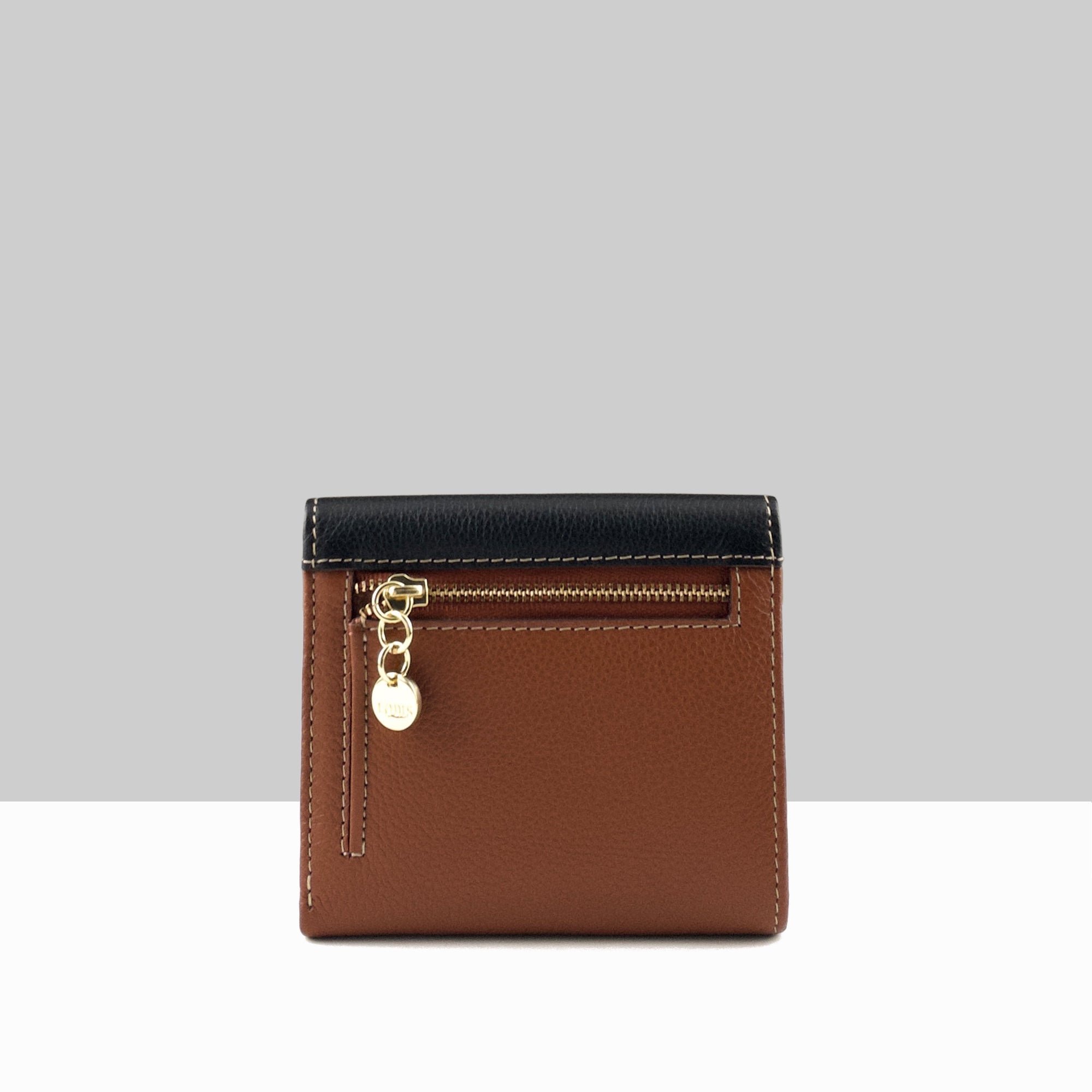 Lodis Vista Envelope Small Tri Fold Wallet in black sand chestnut color block leather showing back view with gold zip pocket and Lodis charm