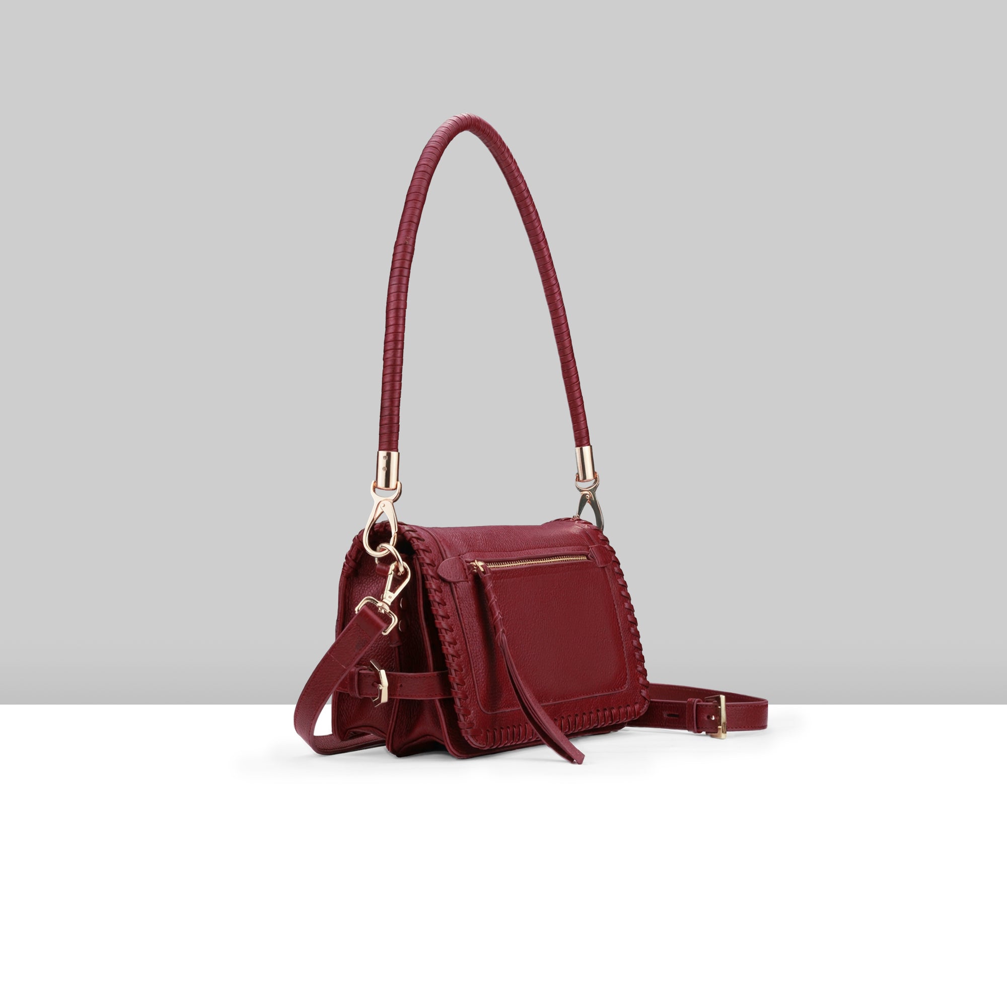 Lodis Elina EW Crossbody wine glazed leather bag with whipstitch trim, front zip pocket, and braided top handle – side view