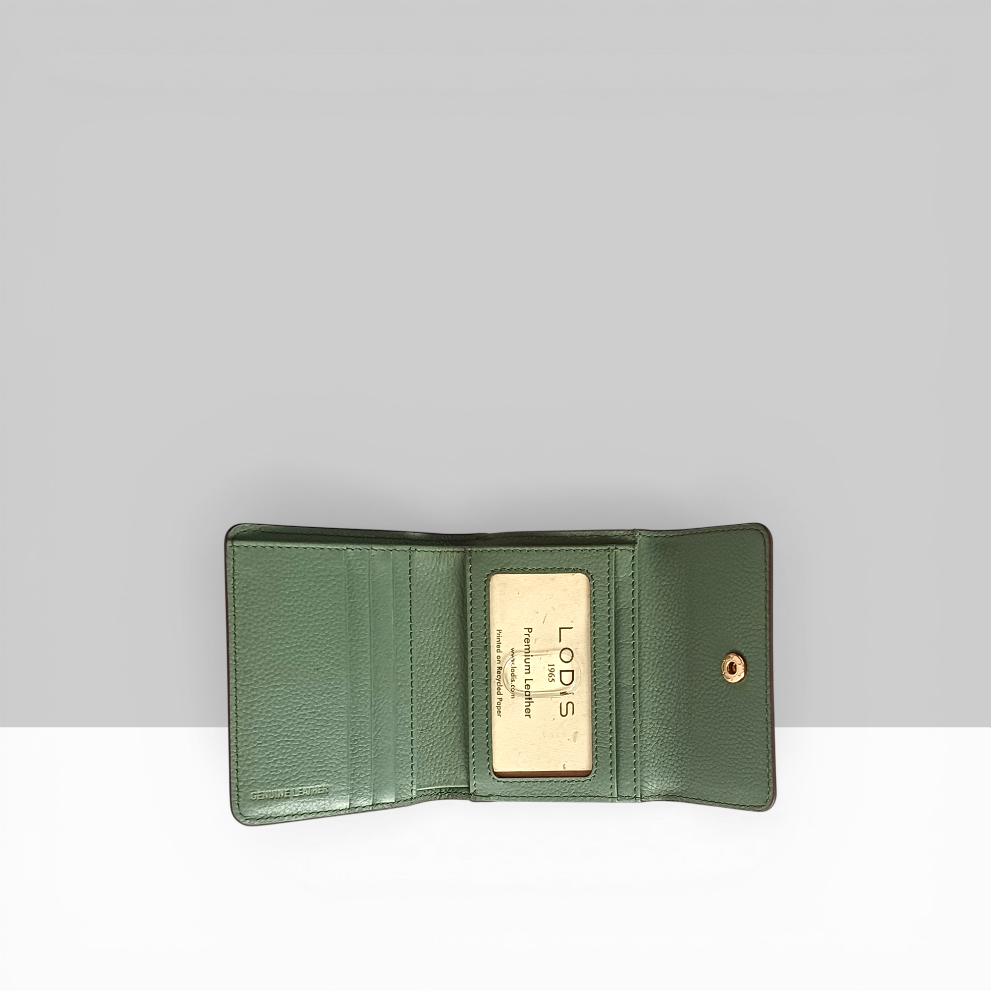 Lodis Kiara French Purse in sage green pebbled leather open view showing card slots, bill compartment, and Lodis branded interior