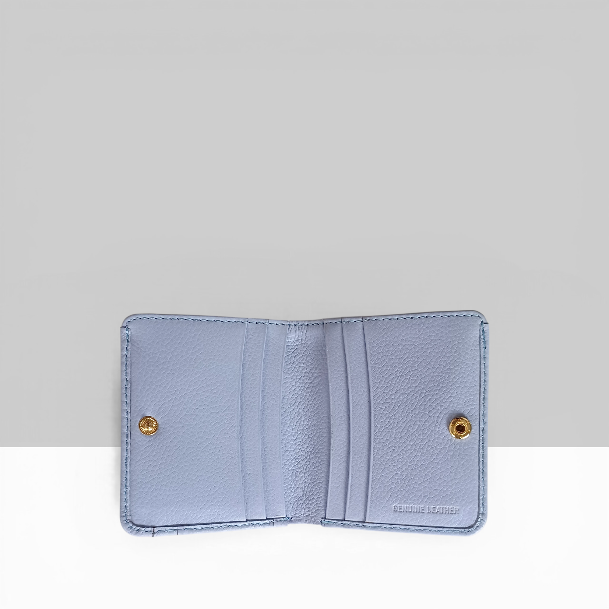 Lodis Kiara Envelope Card Wallet in aura lavender pebbled leather open view showing multiple card slots and gold snap closures