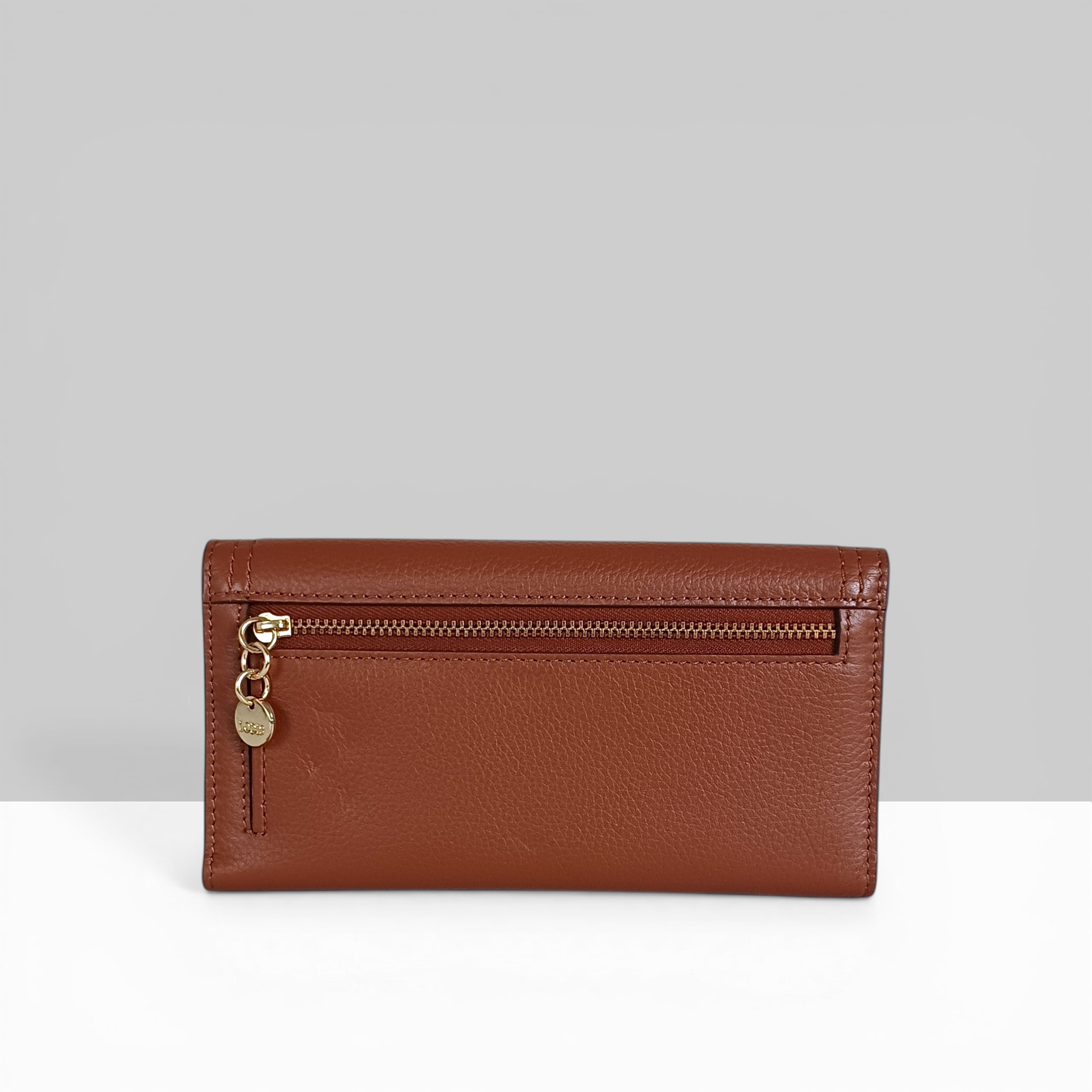 Lodis Kiara Large Flap Wallet in chestnut pebbled leather showing back view with gold zip pocket and Lodis charm