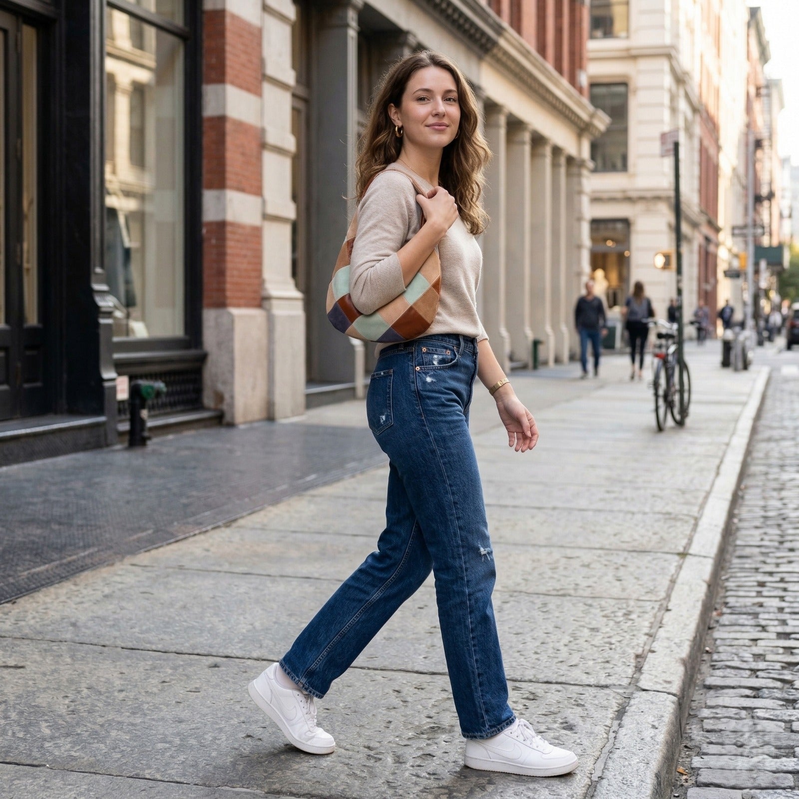 Lodis Willo Patchwork hobo bag in multicolor suede and leather worn over shoulder by a woman walking on a city street in casual outfit