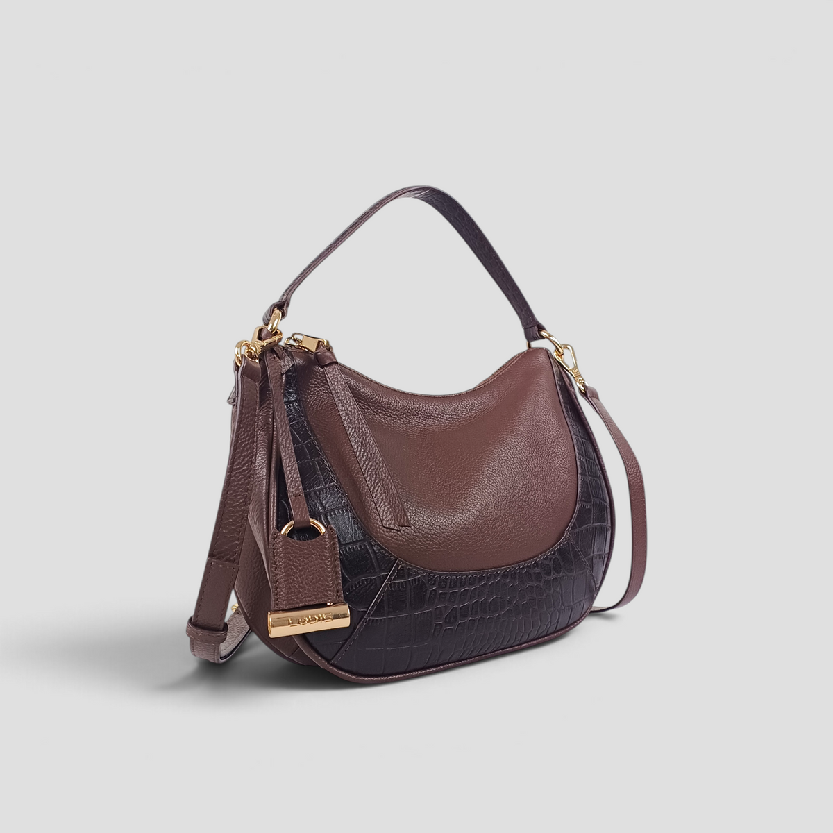 Lodis Amara Top Handle Crossbody in Brownie - Three-Quarter View Showing Two-Tone Texas Leather and Soft Croco Panels, Leather Hang Tag and Gold-Tone Bar Hardware | Lodis 1965