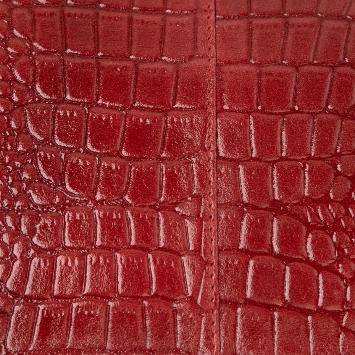 Lodis Amara Zip Pouch in Samba - Macro Texture Detail of Deep Red Glossy Croco-Embossed Leather with Center Seam | Lodis 1965