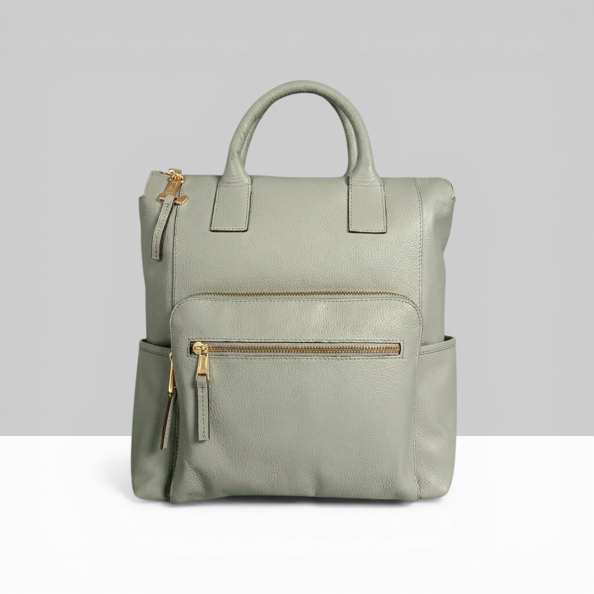 Lodis Catalina 2.0 Leather Backpack in Sage Green – Front View, Drum Dyed Pebbled Leather with Gold-Tone Front Zip Pocket, Top Handle, and Side Pockets | Lodis 1965