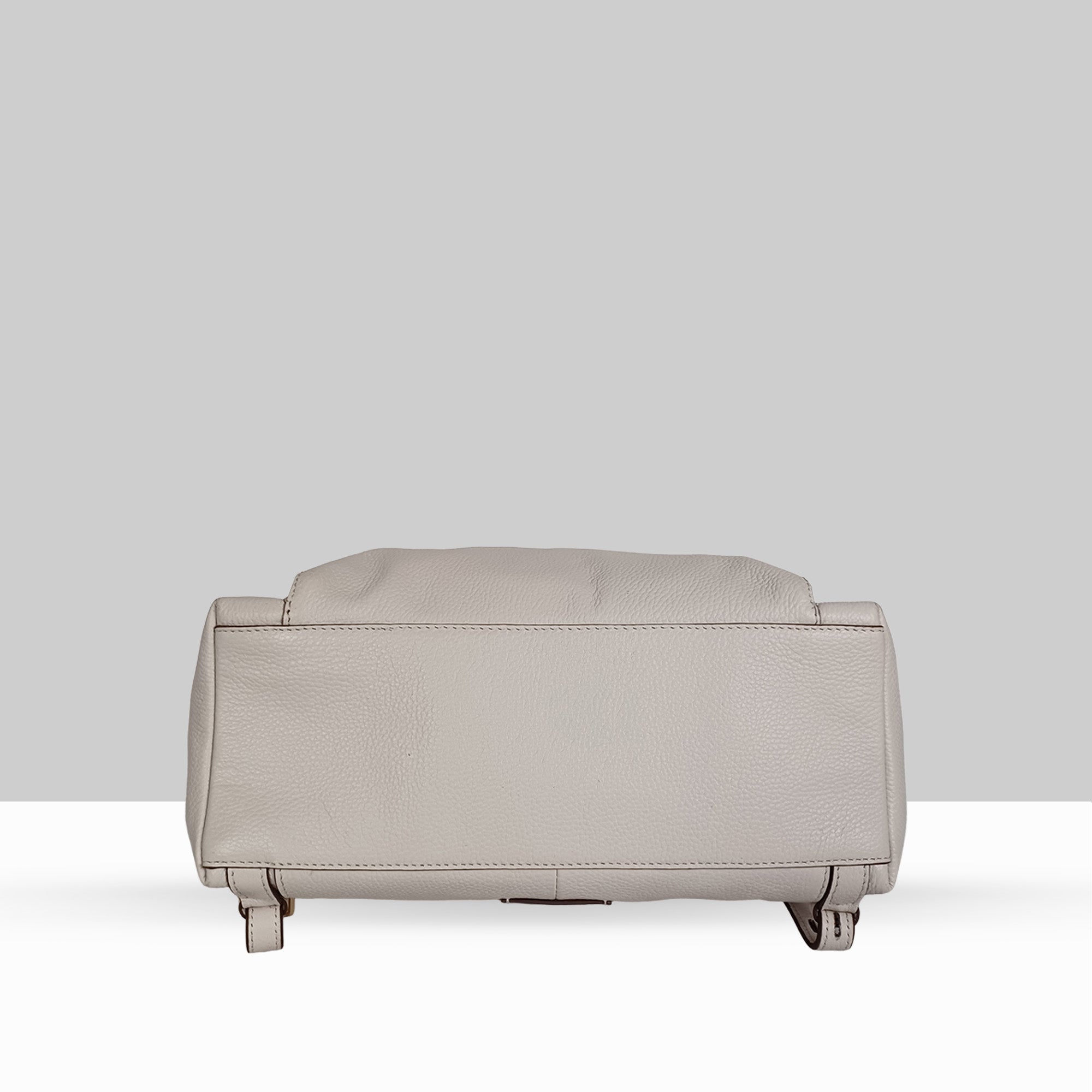 Lodis Catalina 2.0 Leather Backpack in White – Base View Showing Structured Bottom, Pebbled Leather Texture, and Gold-Tone Protective Feet | Lodis 1965