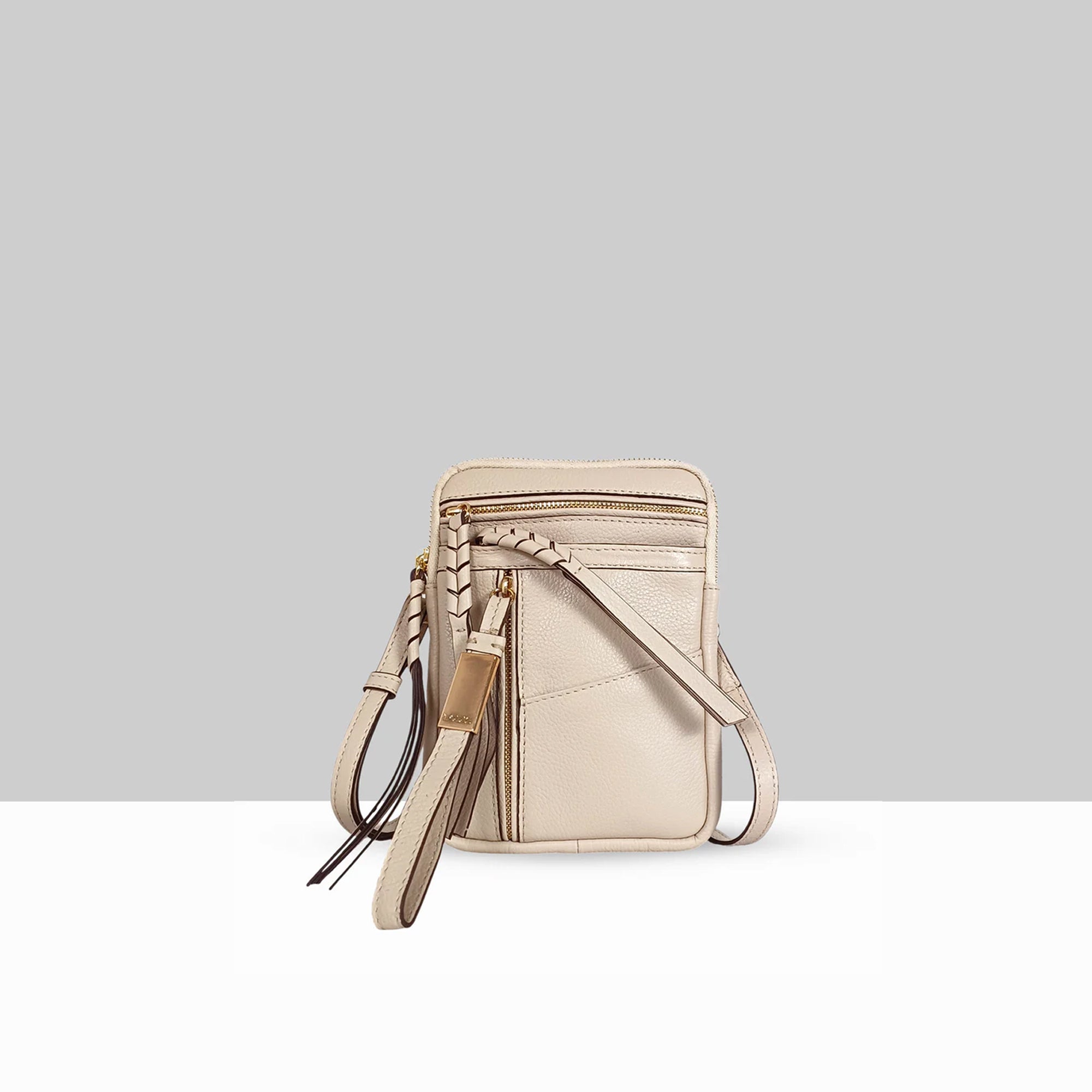 Lodis Catalina 2.0 Phone Crossbody in Sand – Front View, Smooth Cow-Hide Leather with Zip Top, Whipstitch Detail, Front Zip Pocket, and Multi-Tassel Accent | Lodis 1965