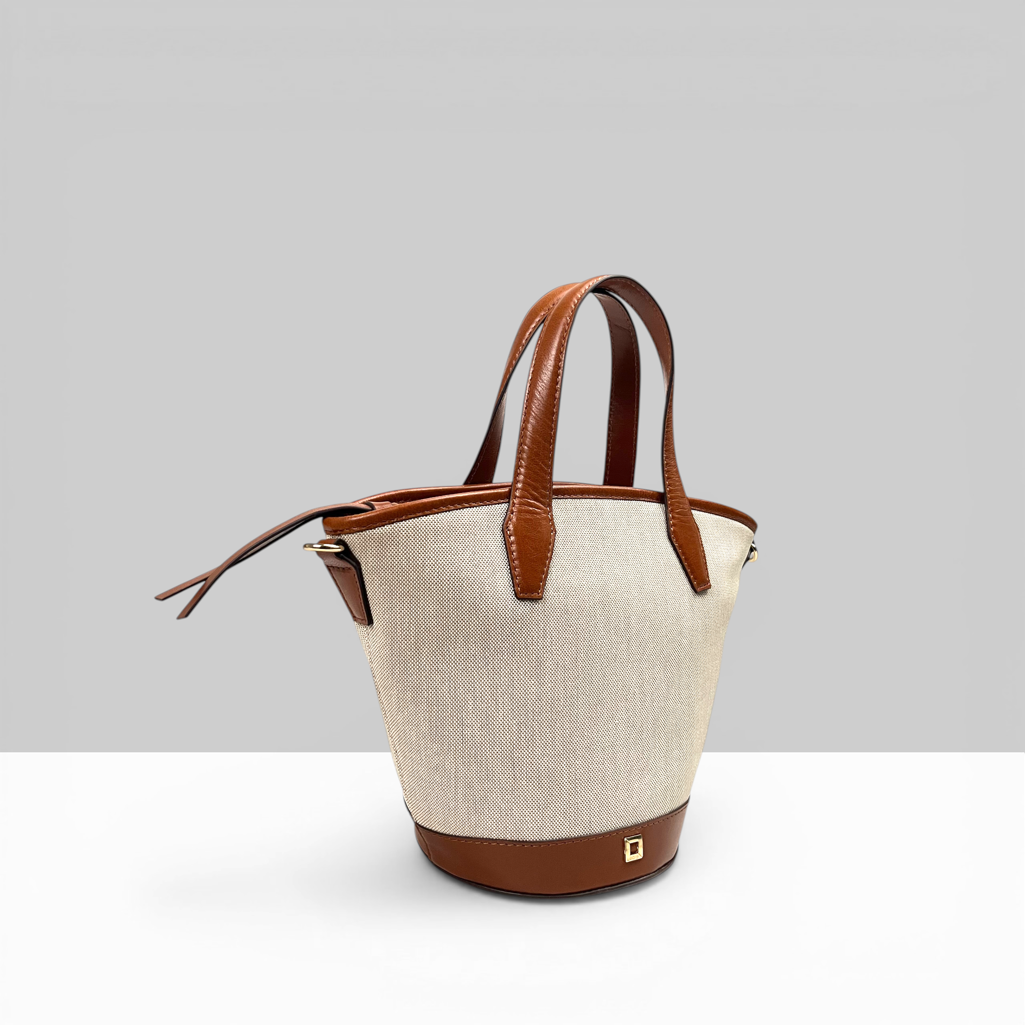 Lodis Kiara Small Bucket Bag in Chestnut – Three-Quarter View Showing Bucket Shape, Chestnut Leather Base and Crossbody Strap | Lodis 1965