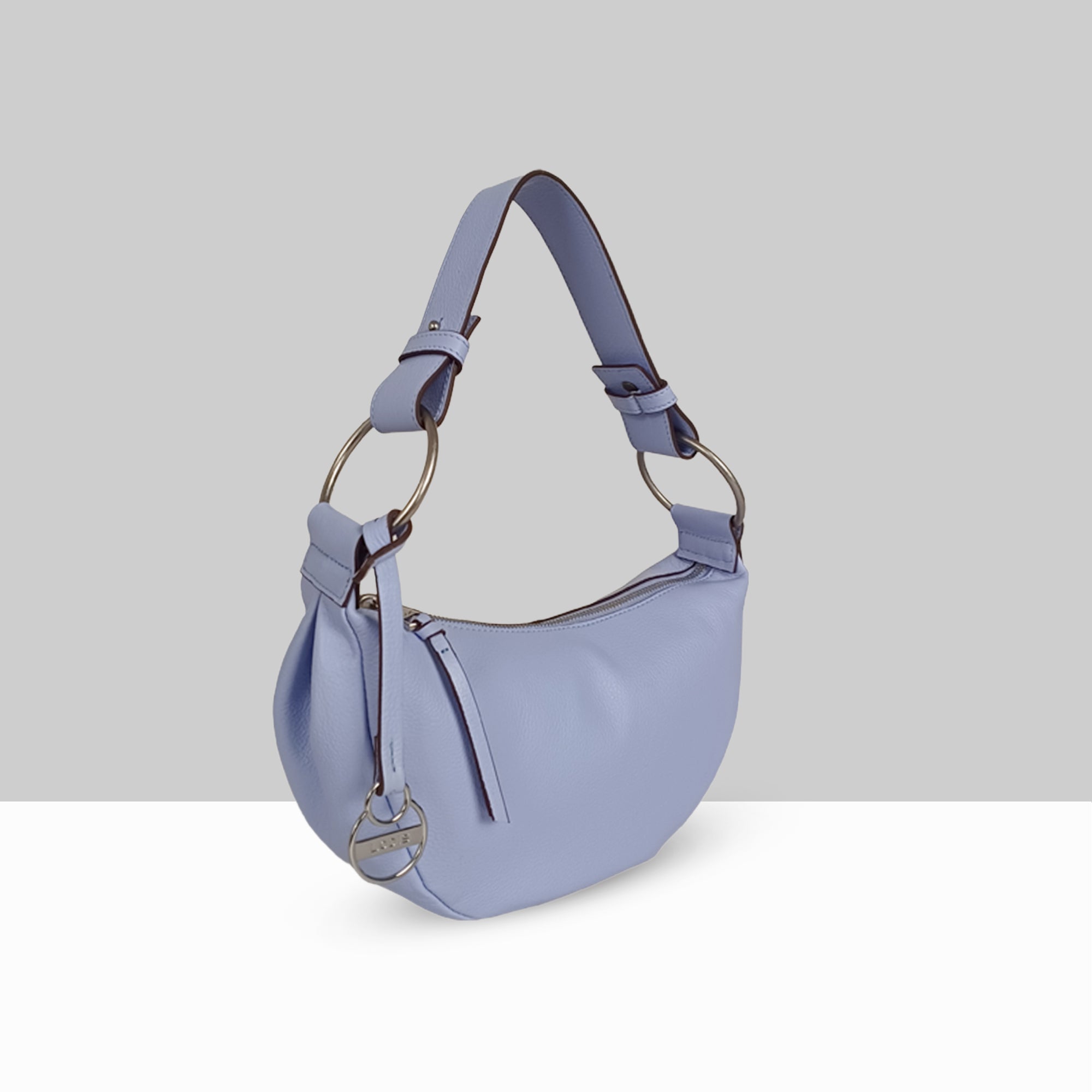 Lodis Solaris Hobo Bag in Aura – Angled View Showing Gold-Tone D-Ring Hardware, Lodis Logo Coin Charm, and Crescent Silhouette | Lodis 1965