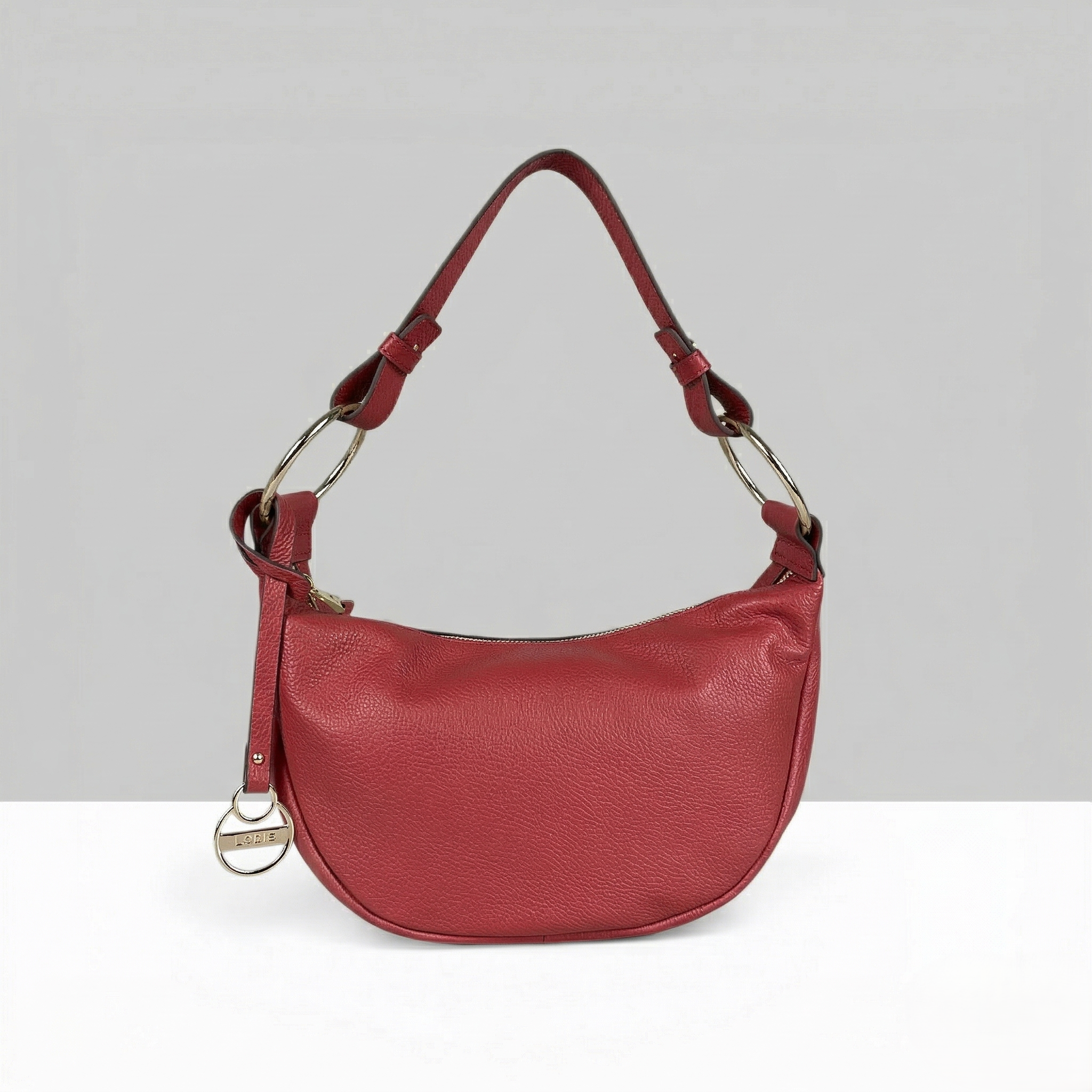 Lodis Solaris Hobo Bag in Rhythmic Red – Front View, Drum Dyed Pebbled Leather Crescent Silhouette with Zip Closure, Gold-Tone D-Ring Hardware, and Logo Coin Charm | Lodis 1965