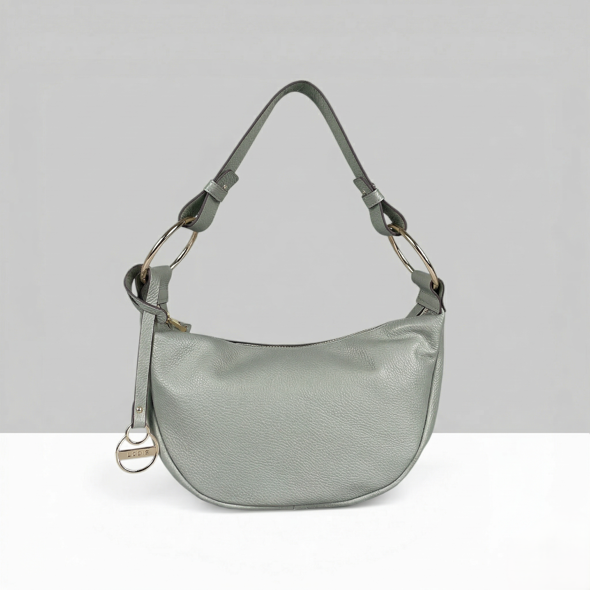 Lodis Solaris Hobo Bag in Sage Green – Front View, Drum Dyed Pebbled Leather Crescent Silhouette with Zip Closure, Gold-Tone D-Ring Hardware, and Logo Coin Charm | Lodis 1965