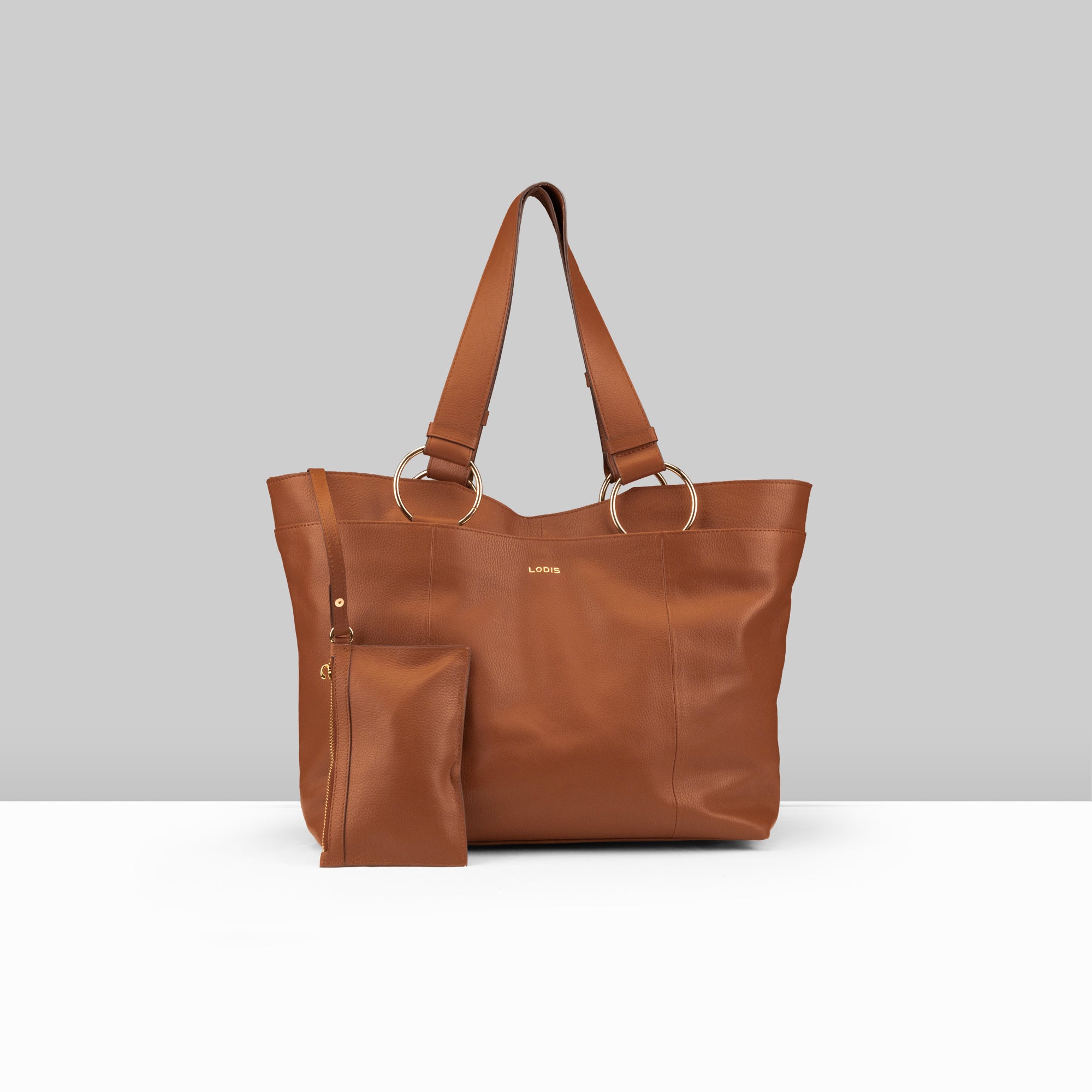 Lodis Solaris Tote in Chestnut β Front View, Drum Dyed Pebbled Leather with Gold-Tone Ring Hardware and Matching Zip Pouch | Lodis 1965