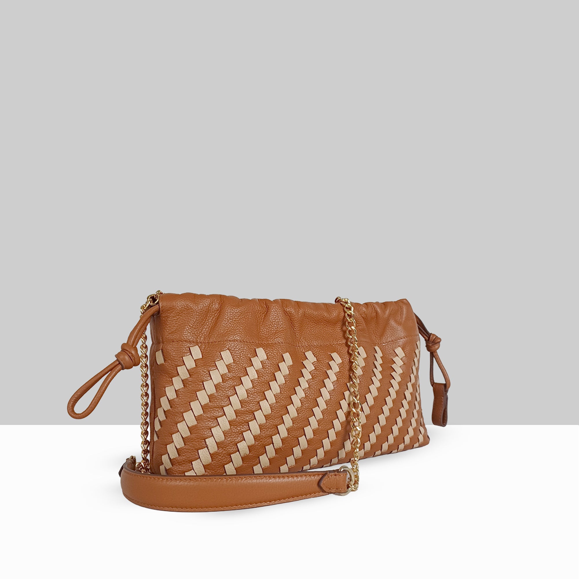 Lodis Solstice Pouch in Chestnut – Angled View Showing Two-Tone Woven Leather, Gold-Tone Chain, Drawstring Knot Ties, and Adjustable Crossbody Strap | Lodis 1965