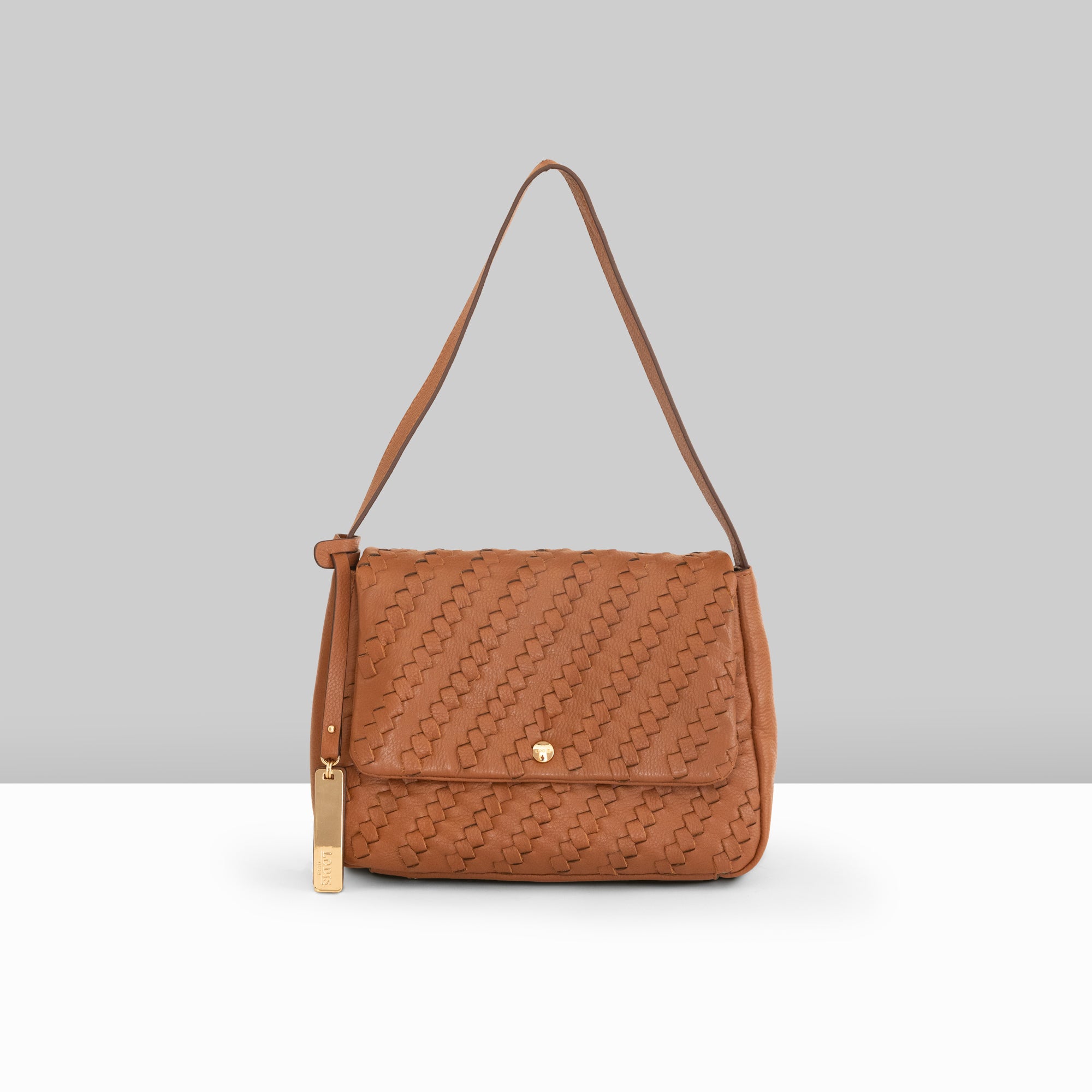 Lodis Solstice Shoulder Bag in Chestnut – Front View, Drum Dyed Woven Pebbled Leather with Flap Closure, Gold-Tone Snap and Tassel Detail | Lodis 1965