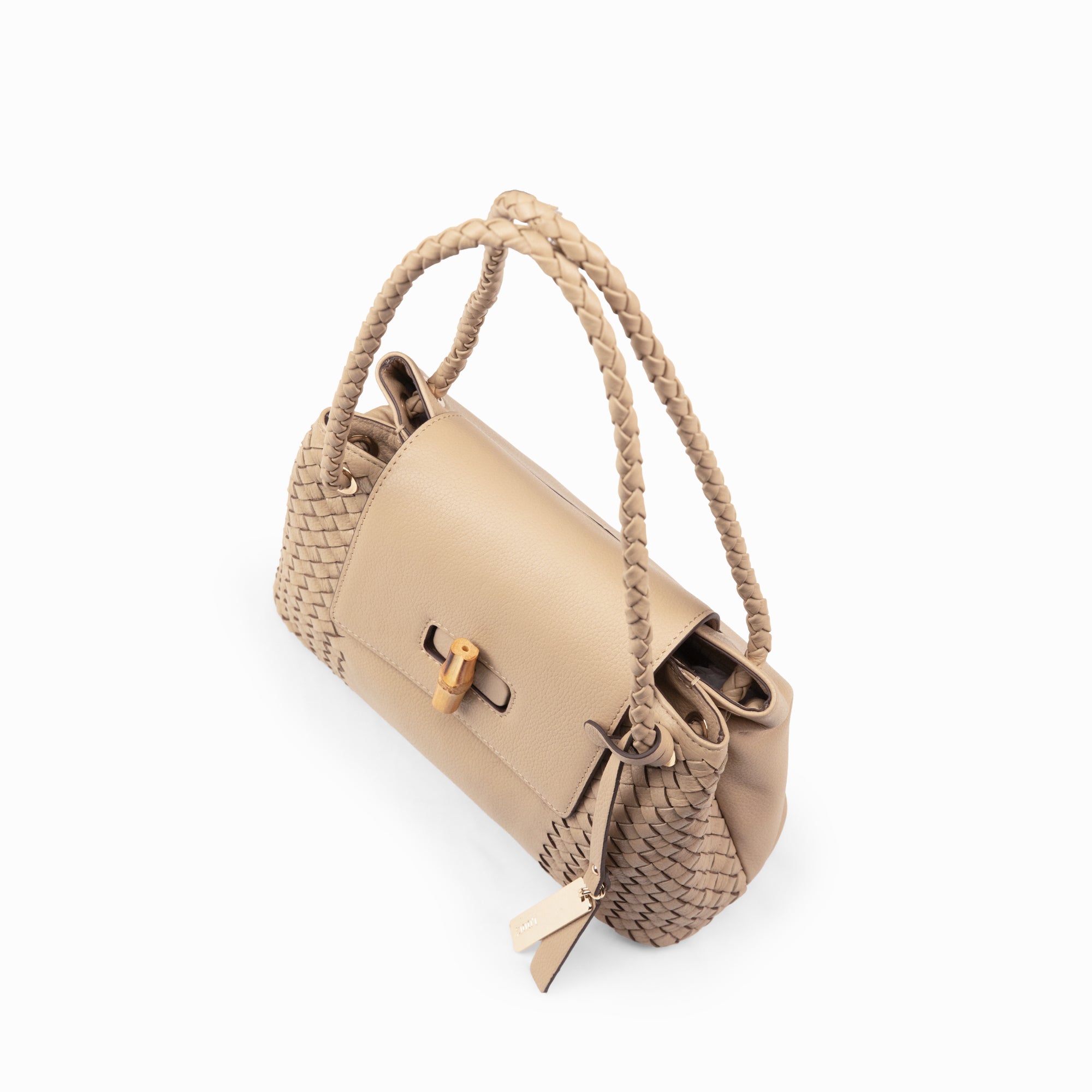 Lodis Sondra Satchel in Sand – Angled Front View, Drum Dyed Pebbled Leather with Woven Body Panels, Braided Handle, Bamboo Turn-Lock, and Gold-Tone Tassel | Lodis 1965