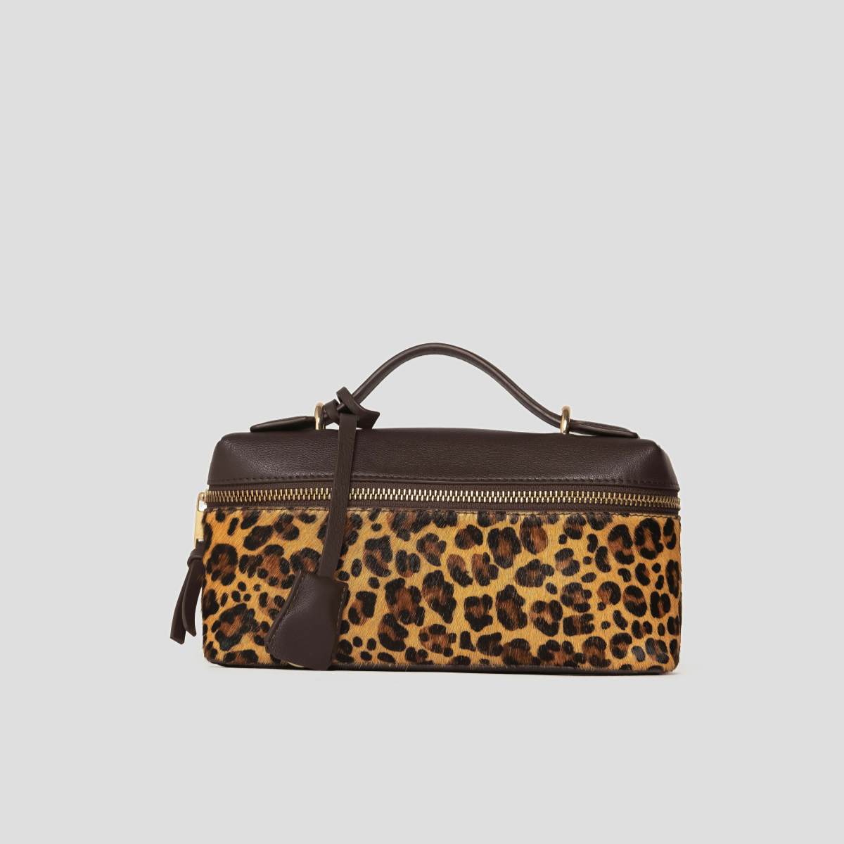 Lodis Stratos Texas Crossbody in Cheetah Print - Angled View Showing Top Handle, Hang Tag and Genuine Hair Calf Leather Front | Lodis 1965