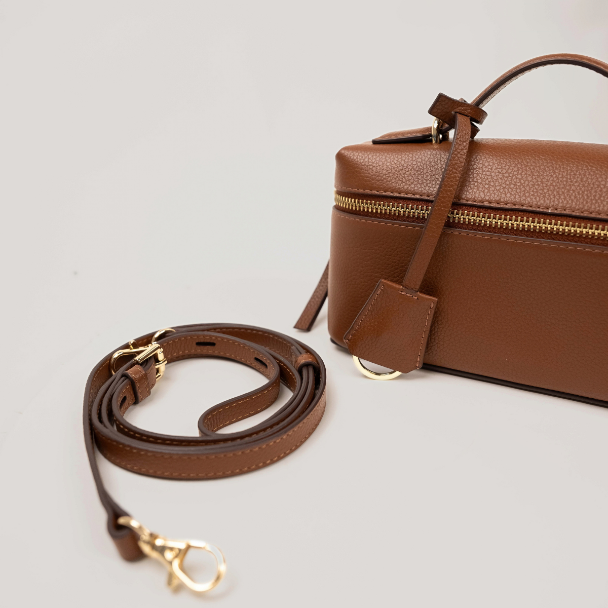 Lodis Stratos Texas Crossbody in Chestnut - Detachable Cognac Texas Leather Crossbody Strap with Gold-Tone Clasps Shown Beside Bag | Lodis 1965