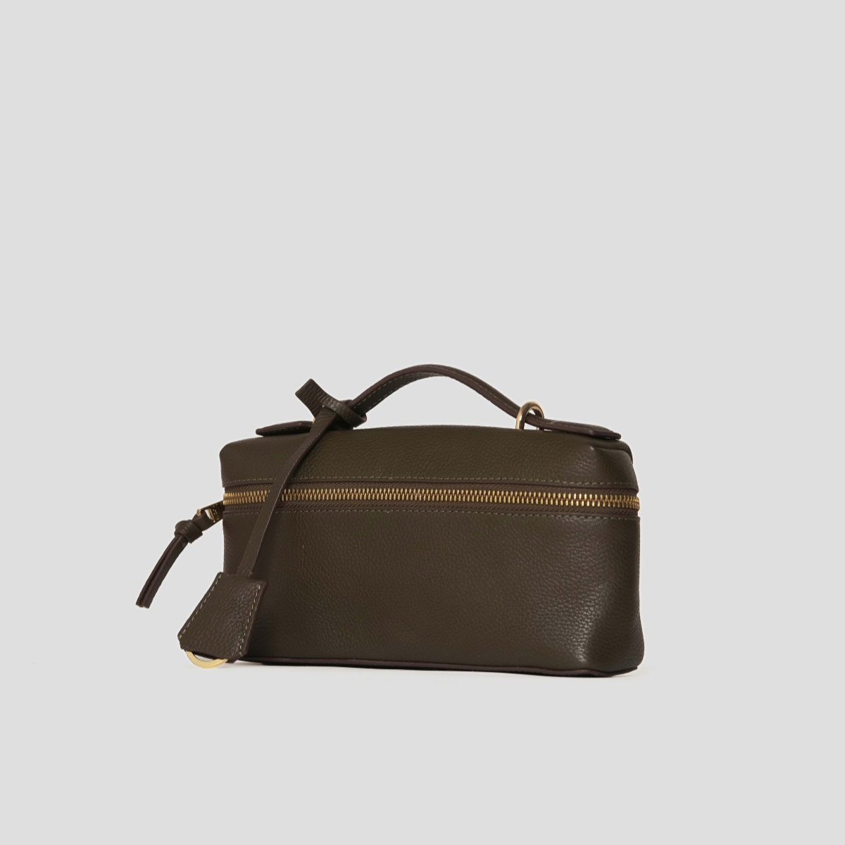 Lodis Stratos Texas Crossbody in Olivine - Three-Quarter View Showing Structured Box Shape, Knotted Top Handle and Hang Tag | Lodis 1965