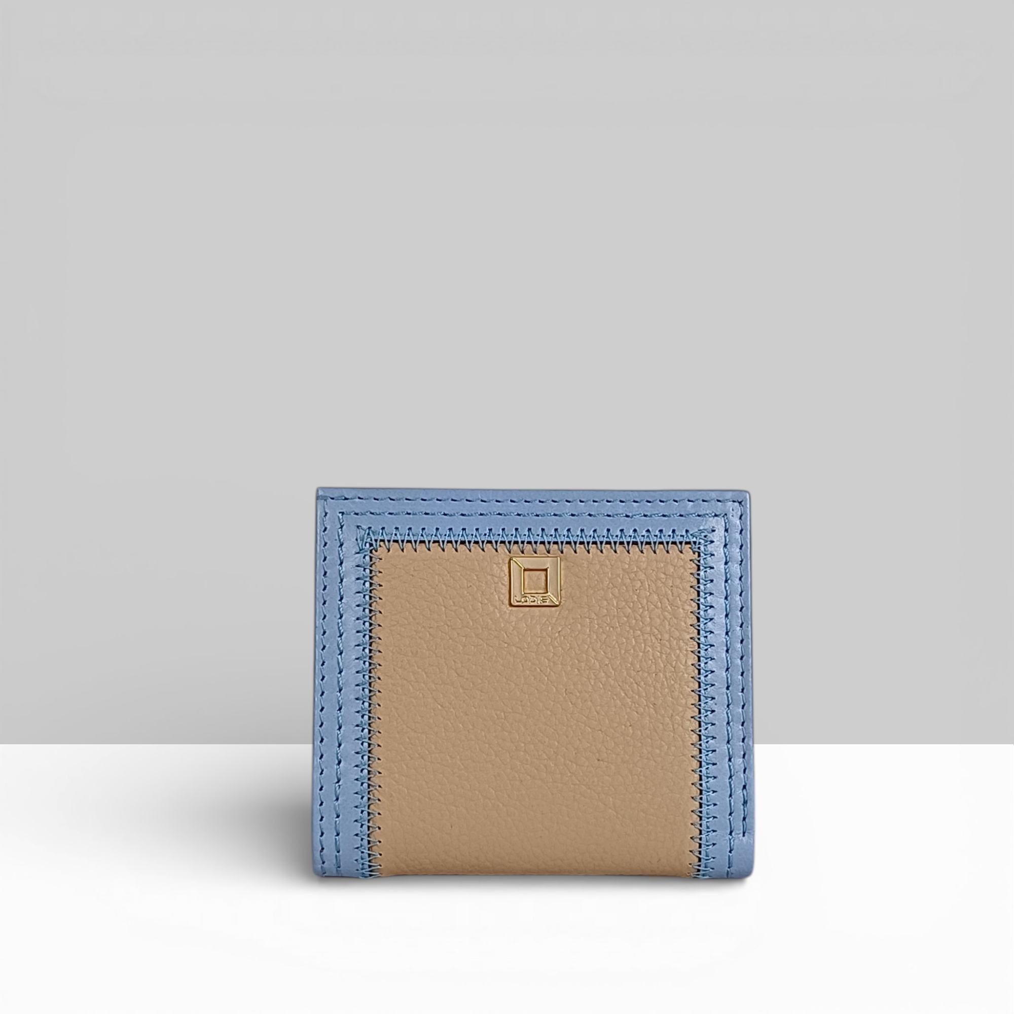 Cafe Slim Wallet in Aura Blue and Sand Two-Tone Leather – Front View with Gold Square Snap Closure and Contrast Stitching | Lodis 1965