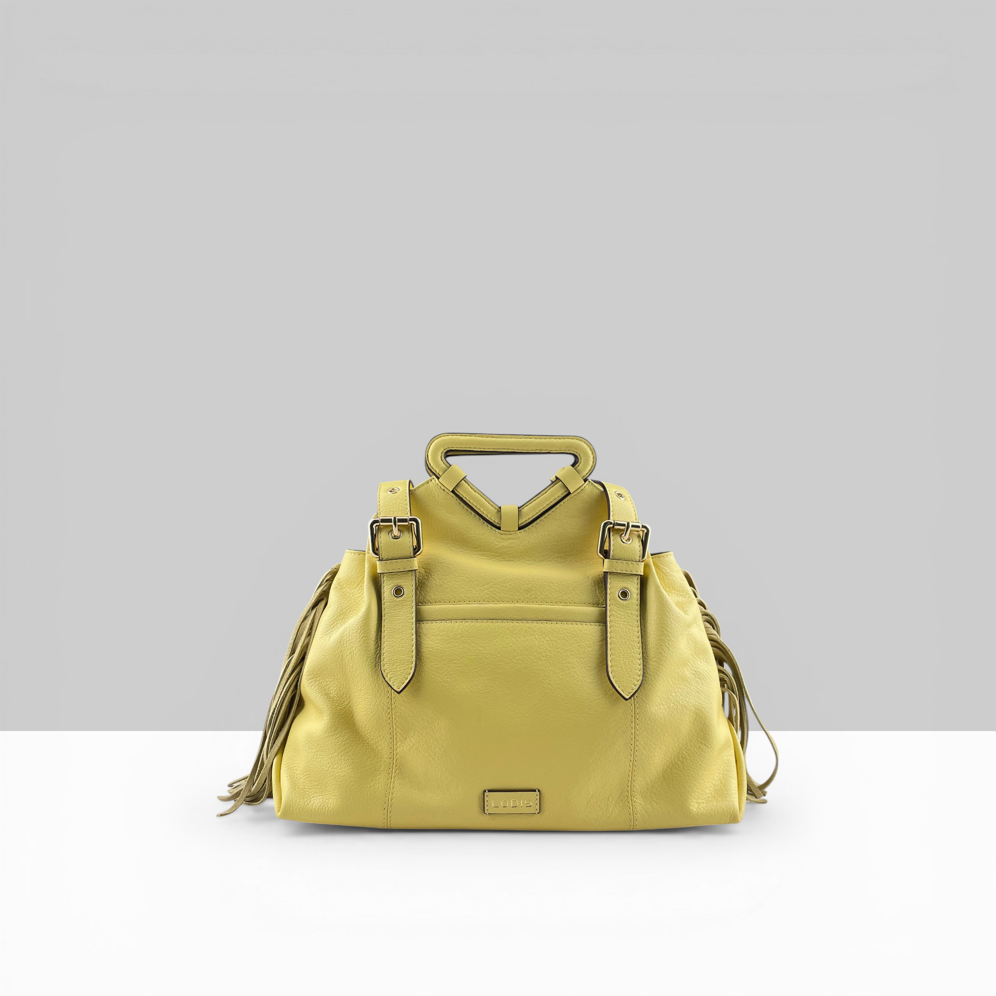 Lodis Skya Tote yellow leather women's handbag with fringe detail, top handle, and gold buckle straps – front view