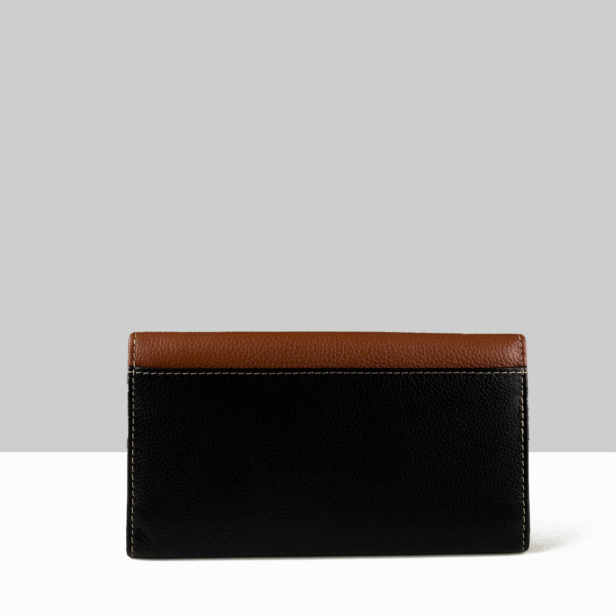 Lodis Vista Envelope Trifold Wallet in black chestnut sand color block pebbled leather showing back view with contrast stitching