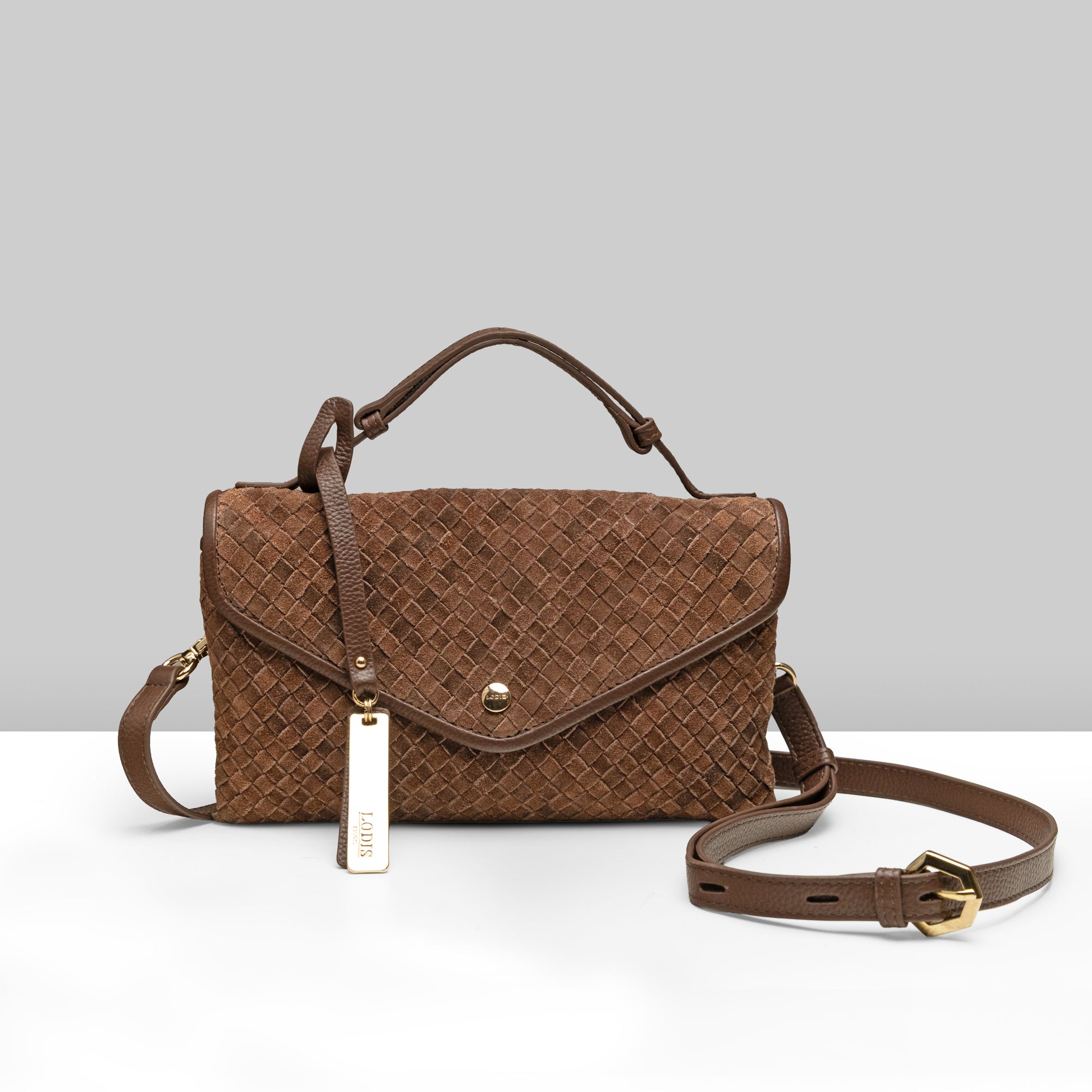Lodis Meridian EW Crossbody chestnut woven suede leather crossbody bag with top handle, flap closure, gold snap, and Lodis tag