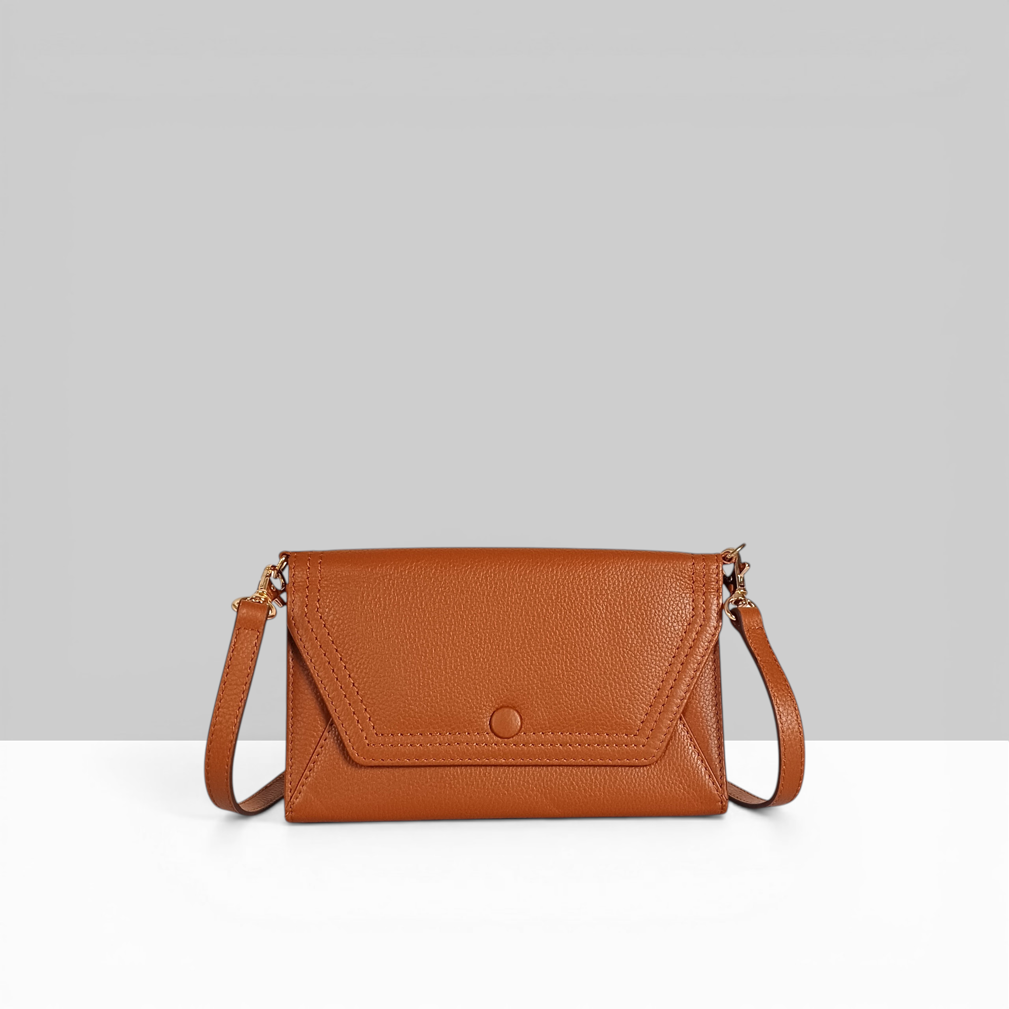 Lodis Kiara EW Sling chestnut pebbled leather crossbody bag with flap closure, snap button, and gold hardware – front view