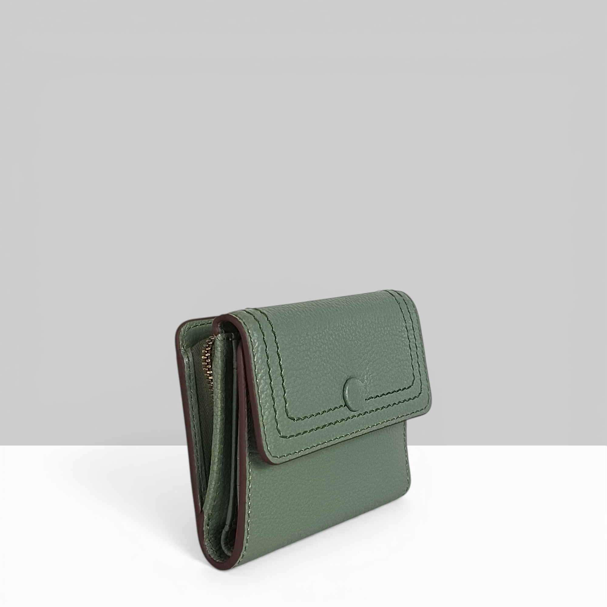 Lodis Kiara French Purse in sage green pebbled leather showing side view with zip coin pocket and snap flap closure