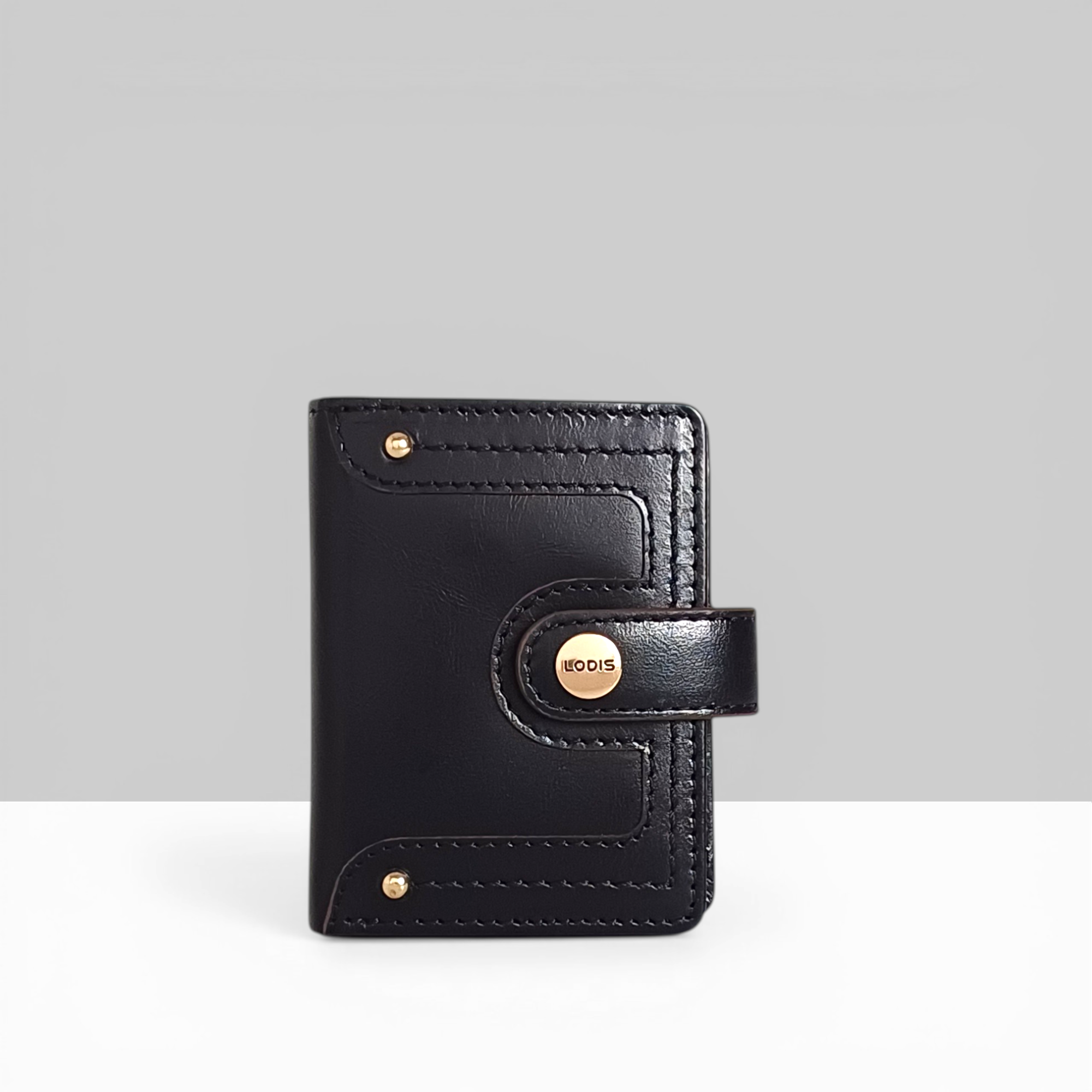 Lodis Overglow Slim Wallet in Black Leather with Gold Snap Closure and Logo Detail