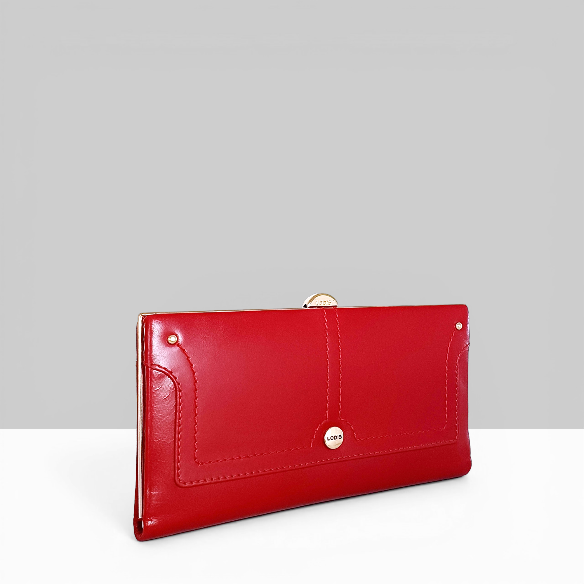 Overglow Clutch Frame Wallet in Rhythmic Red Patent Leather – Angled Side View Showing Rose Gold Frame Hardware and Topstitched Edge Detail | Lodis 1965