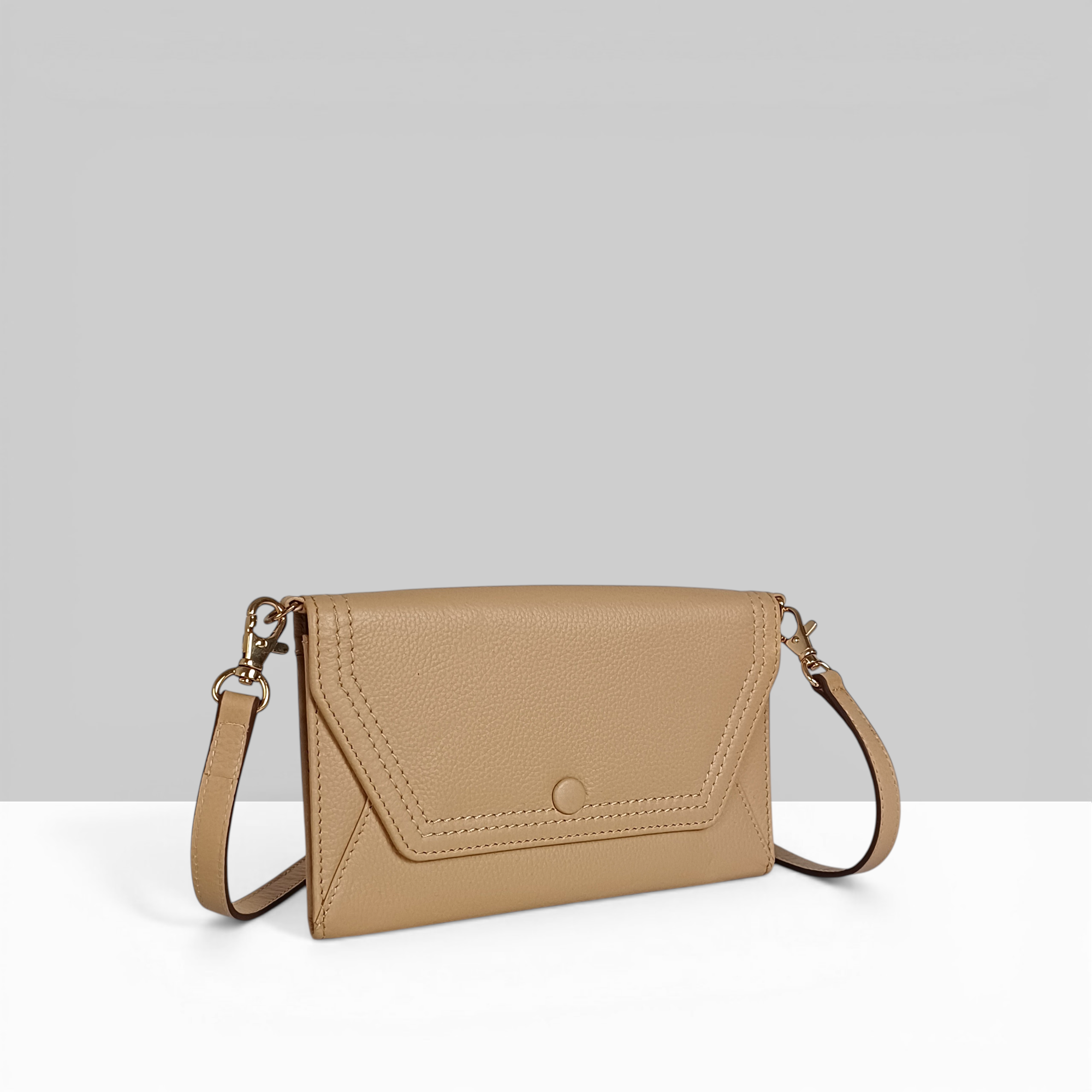 Lods Kiara EW Sling sand pebbled leather crossbody bag with flap closure, snap button, and gold hardware – side angle view