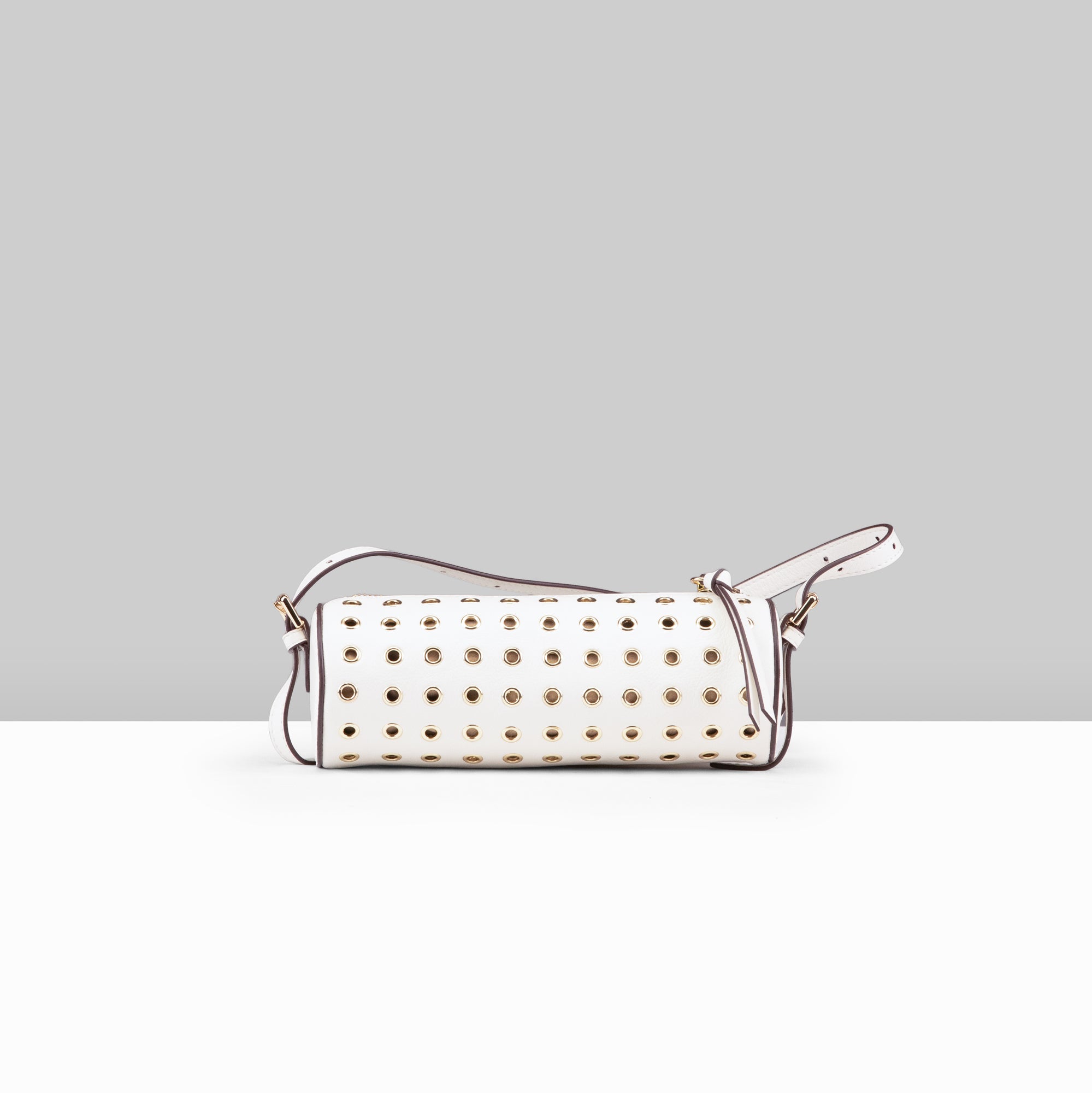Lodis Stephanie Barrel Bag white leather crossbody bag with all-over gold grommet detail and adjustable strap