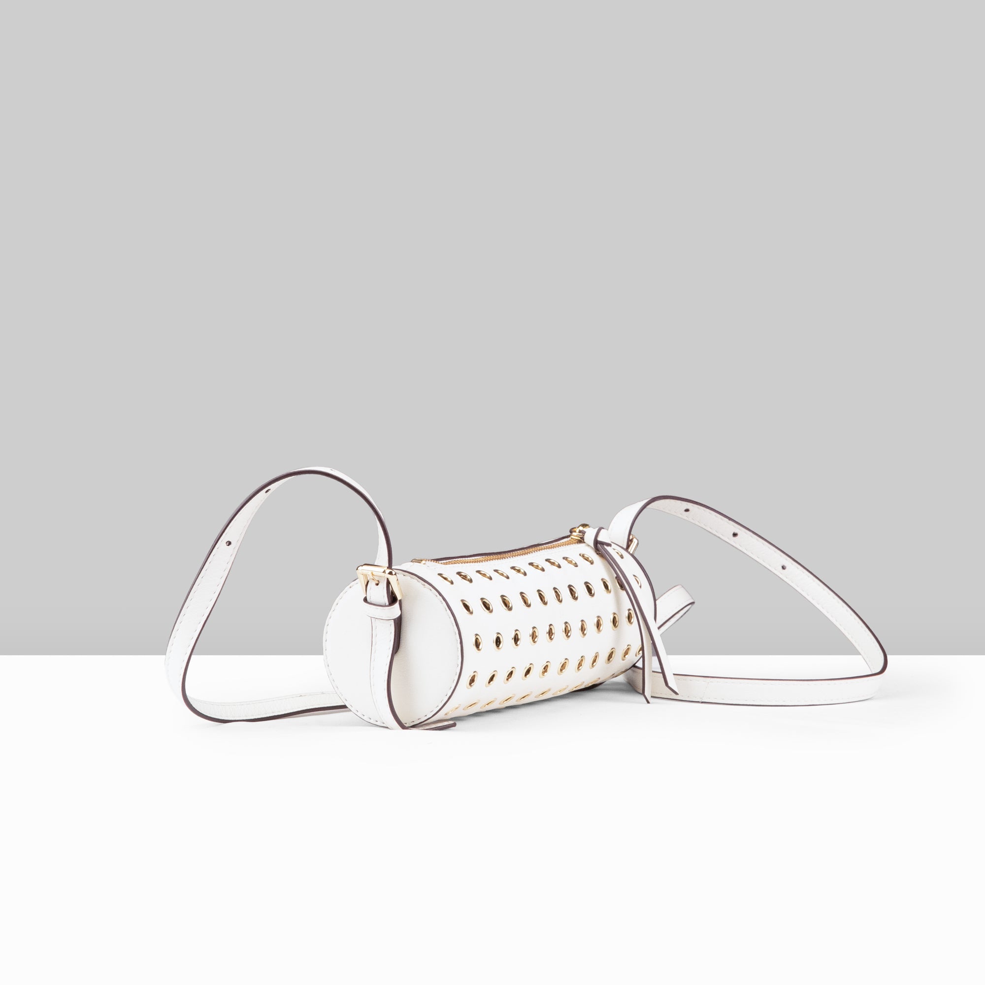 Lodis Stephanie Barrel Bag white leather crossbody bag with all-over gold grommet detail shown from multiple angles
