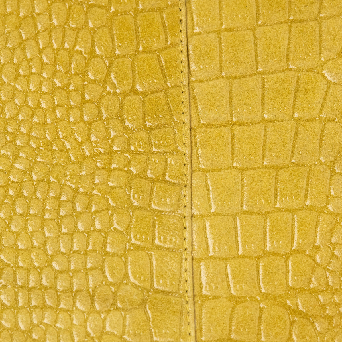 Lodis Amara Zip Pouch in Curry - Macro Texture Detail of Mustard Yellow Glossy Croco-Embossed Leather with Center Seam | Lodis 1965