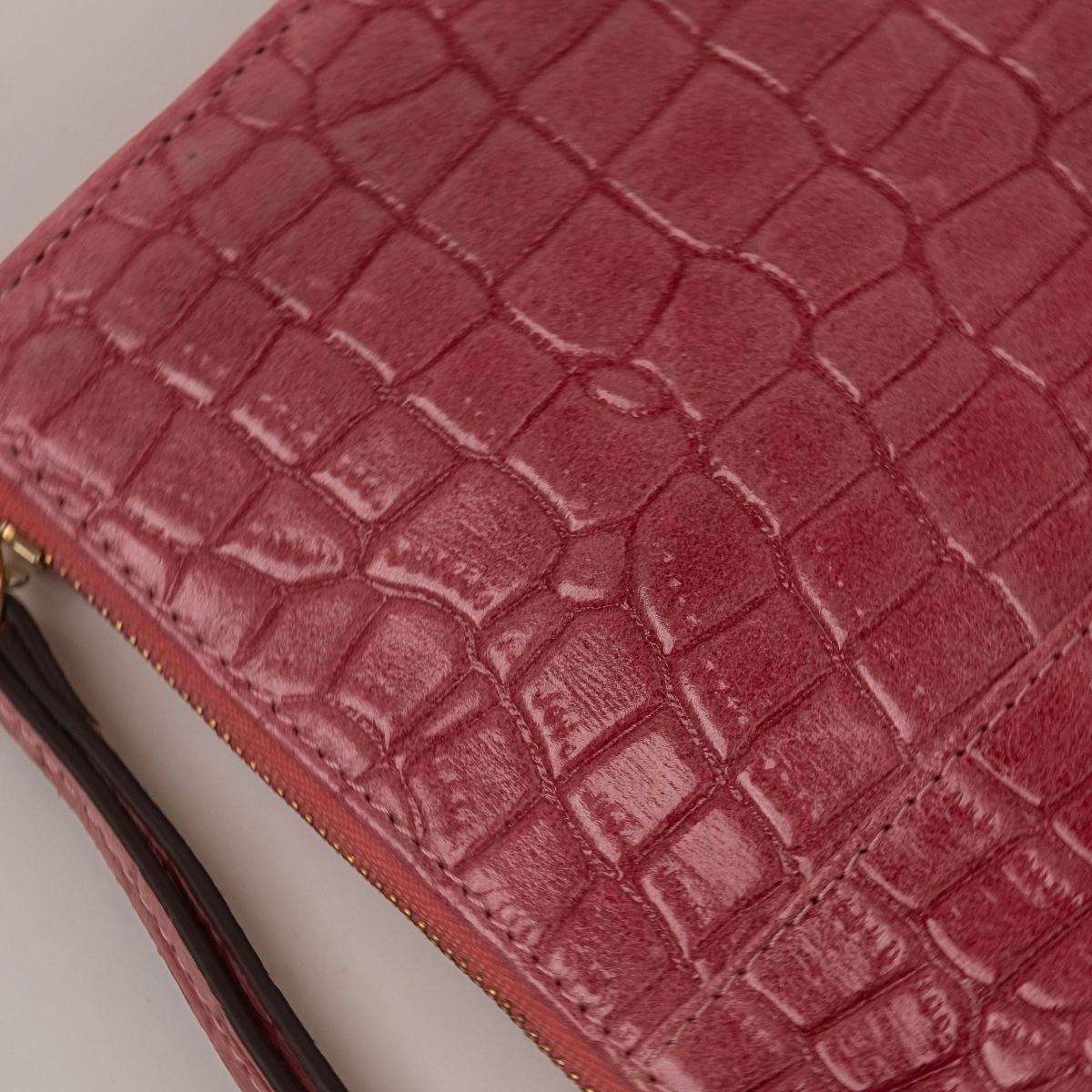 Lodis Amara Zip Pouch in Glossy Pink - Macro Texture Detail of Rose Pink Glossy Croco-Embossed Leather with Zip Corner | Lodis 1965