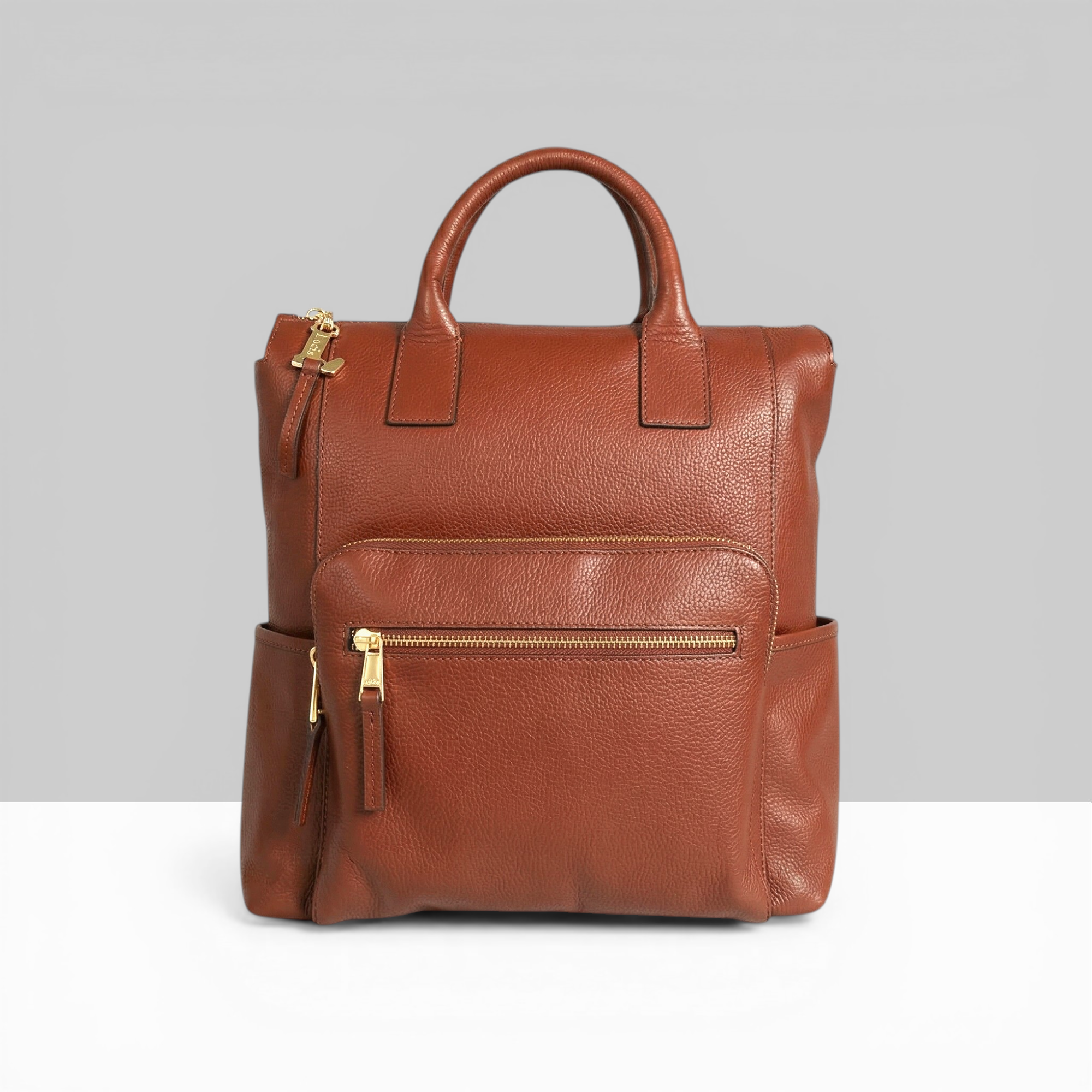 Lodis Catalina 2.0 Leather Backpack in Chestnut – Front View, Drum Dyed Pebbled Leather with Gold-Tone Front Zip Pocket, Top Handle, and Side Pockets | Lodis 1965