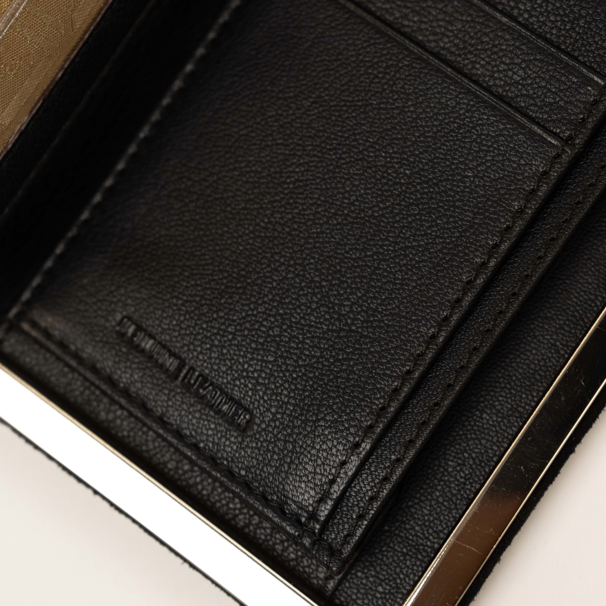 Lodis Celara Frame Clutch in Black - Interior Close-Up of Pebbled Genuine Leather Card Slot with Debossed Stamp, Tonal Stitching and Gold-Tone Frame Edge | Lodis 1965