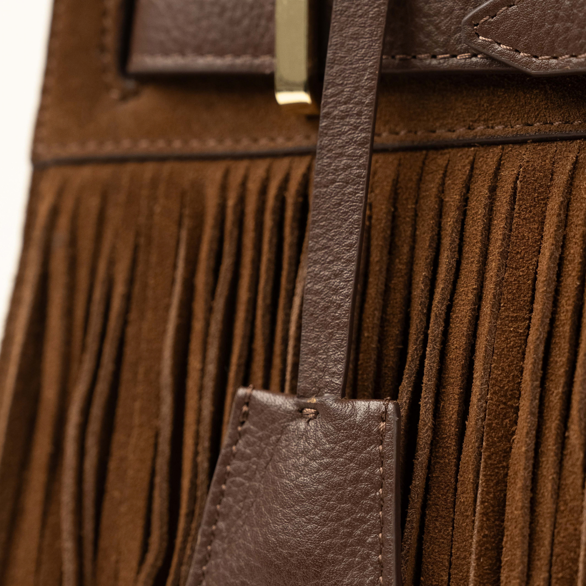 Lodis Ceres Satchel in Brown - Close-Up of Chocolate Brown Suede Fringe with Texas Leather Hang Tag and Gold-Tone Belt Keeper | Lodis 1965