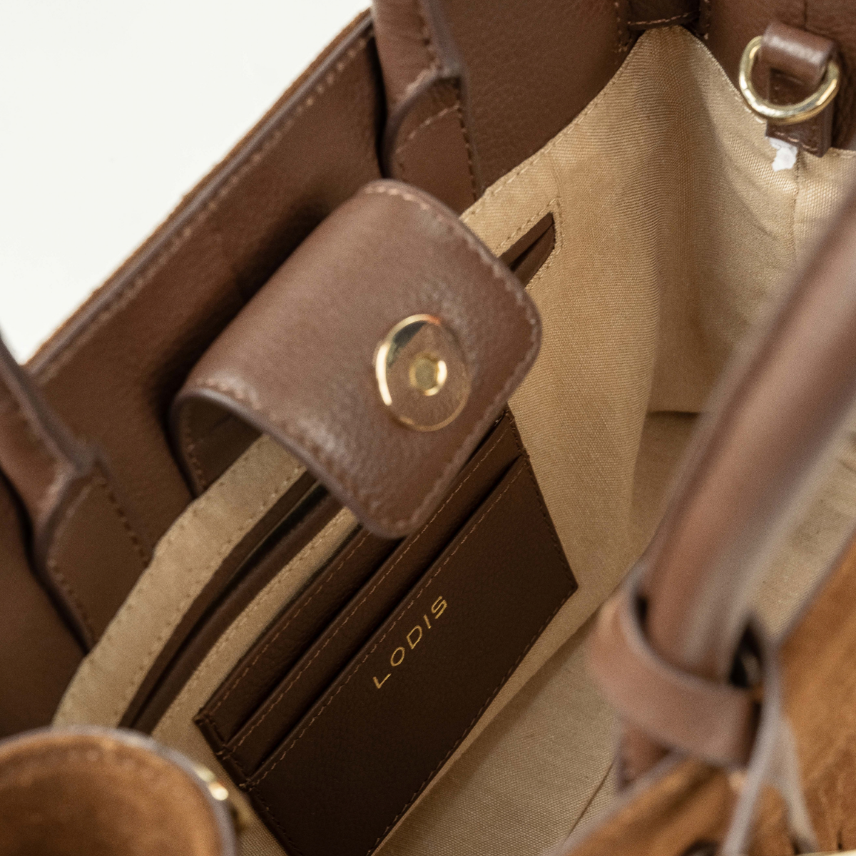 Lodis Ceres Satchel in Brown - Interior View Showing Snap Tab Closure, Leather Slip Pocket with Lodis Logo and Light Fabric Lining | Lodis 1965