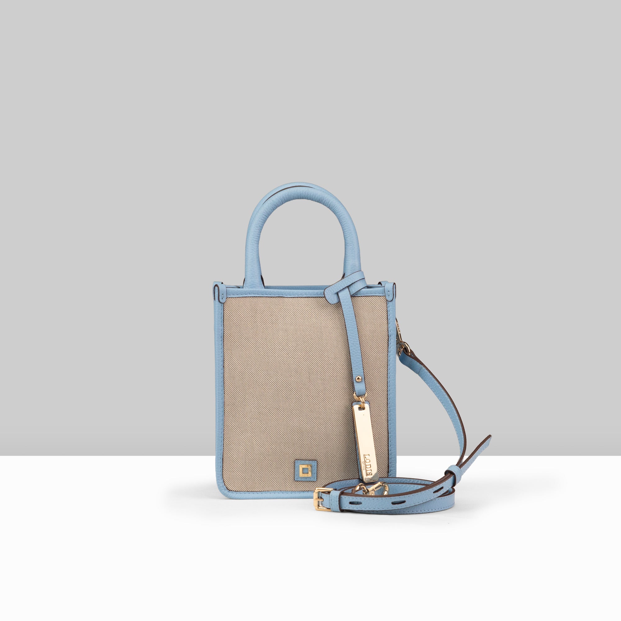 Lodis Kiara City Crossbody in Aura – Front View, Blended Fabric Body with Blue Leather Trim, Top Handle and Adjustable Crossbody Strap | Lodis 1965