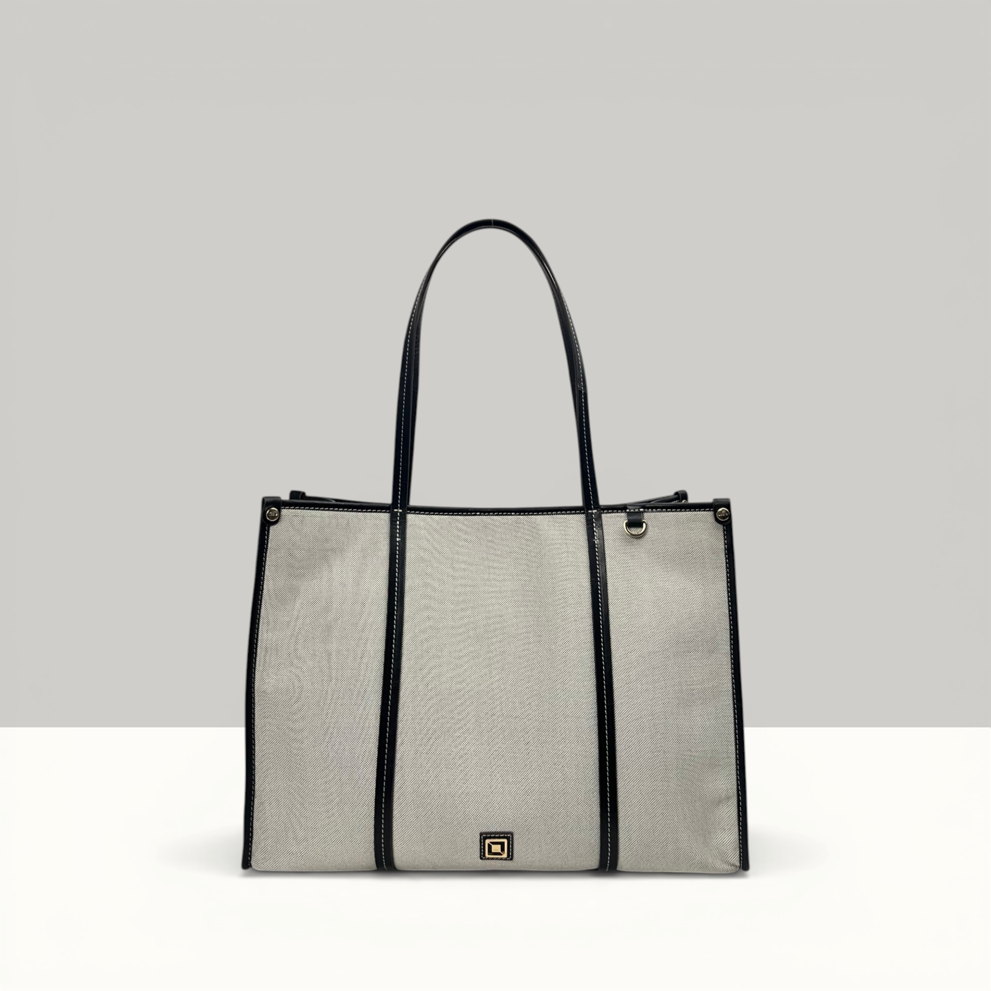 Lodis Kiara Tote in Black – Front View, Blended Fabric Body with Black Leather Trim, Handles and Logo Plate | Lodis 1965