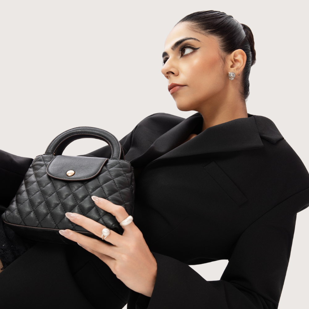 Woman Holding Lodis Mini Quilted Satchel in Black – Lifestyle Shot, Dressed in All-Black Outfit | Lodis 1965
