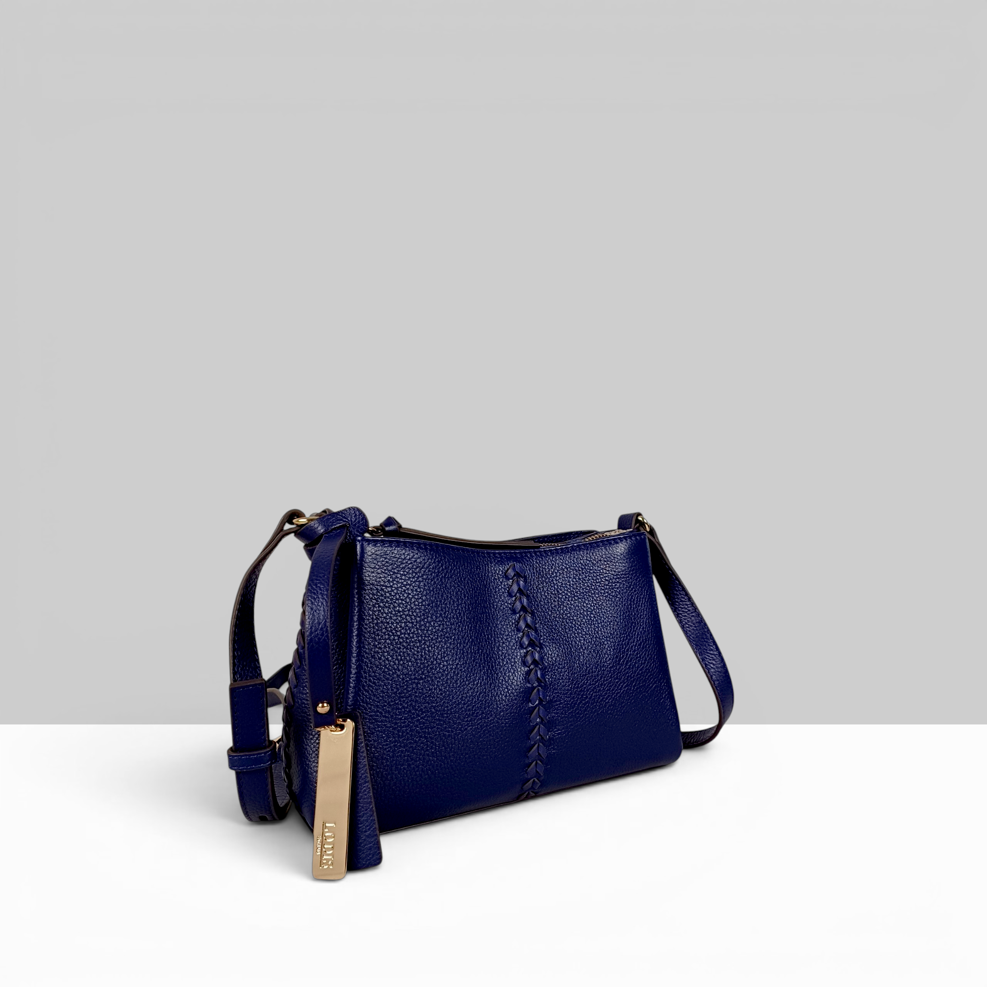 Lodis Nicks Crossbody in Evening Blue - Three-Quarter Front View, Pebbled Suede Leather with Whipstitch Panel Detail, Gold-Tone Hardware and Adjustable Strap | Lodis 1965