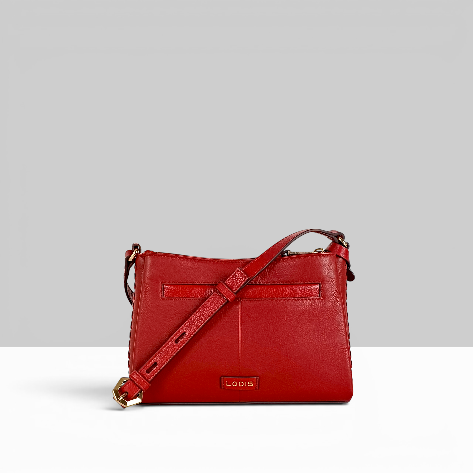 Lodis Nicks Crossbody in Rhythmic Red - Back View Showing Exterior Slip Pocket, Lodis Logo Plate and Adjustable Strap | Lodis 1965