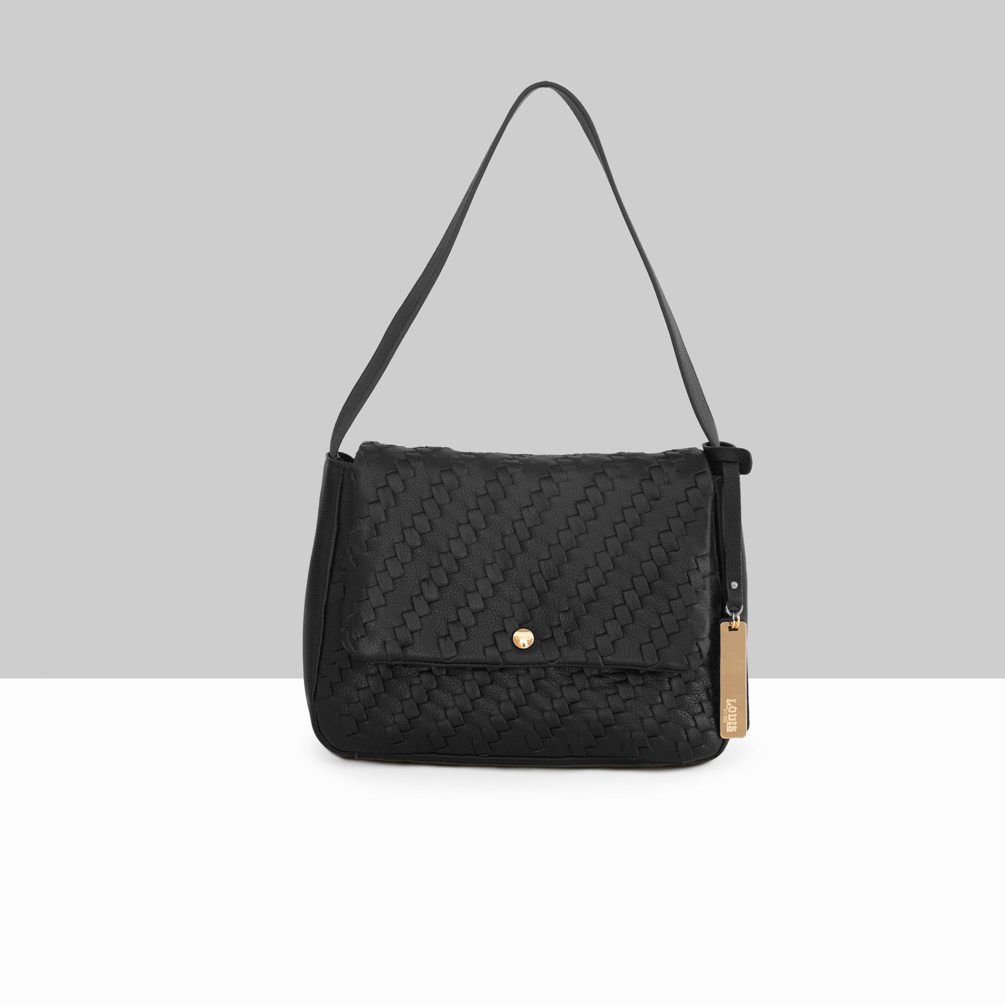 Lodis Solstice Shoulder Bag in Black – Front View, Drum Dyed Woven Pebbled Leather with Flap Closure, Gold-Tone Snap and Tassel Detail | Lodis 1965