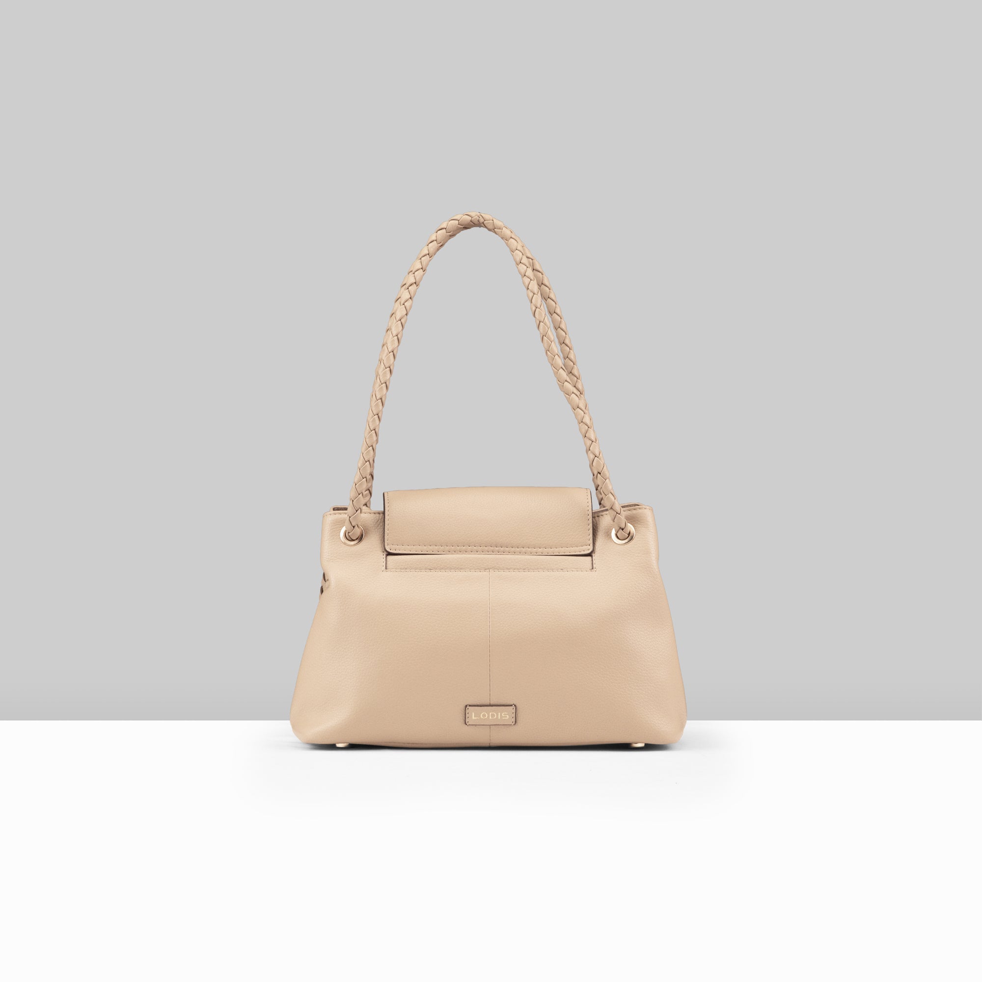 Lodis Sondra Satchel in Sand – Back View Showing Smooth Pebbled Leather Panel, Lodis Logo Plate, Gold-Tone Protective Feet, and Braided Handle | Lodis 1965