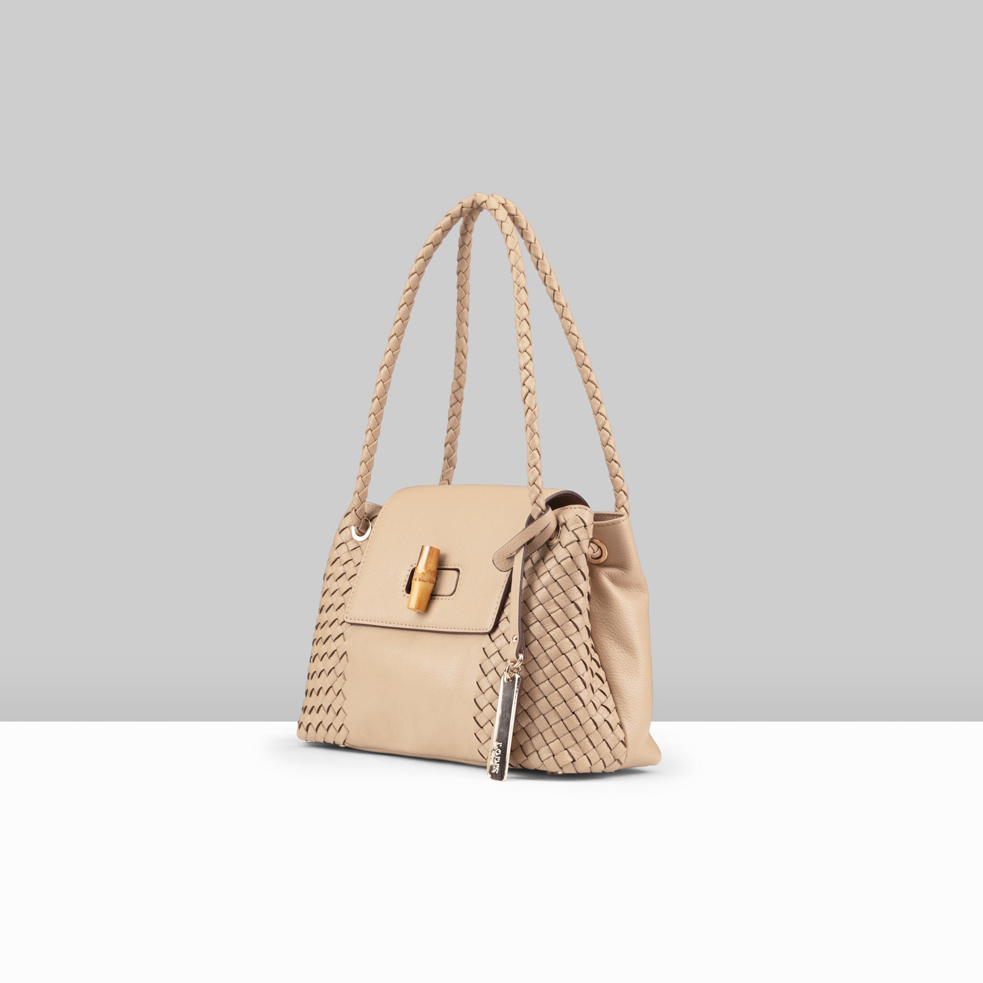 Lodis Sondra Satchel in Sand – Side Profile Showing Bag Depth, Woven Leather Side Panel, Braided Handle, and Bamboo Turn-Lock Detail | Lodis 1965