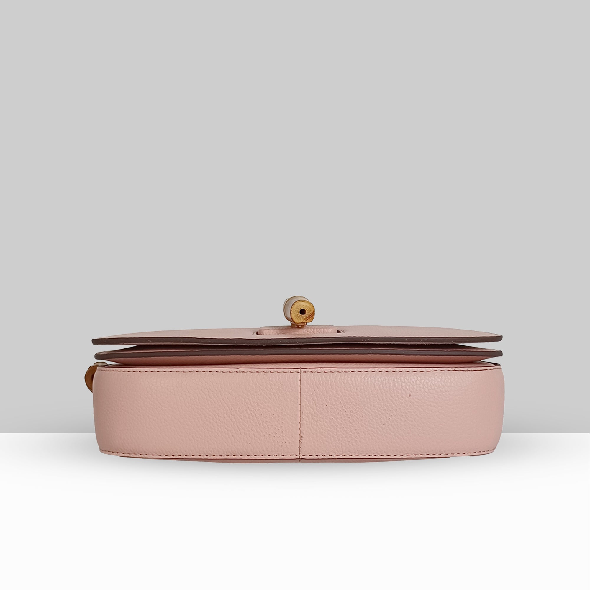 Lodis Sondra Top Handle Crossbody in Dusty Rose – Base View Showing Structured Bottom, Drum Dyed Pebbled Leather Texture, and Gold-Tone Stud Detail | Lodis 1965