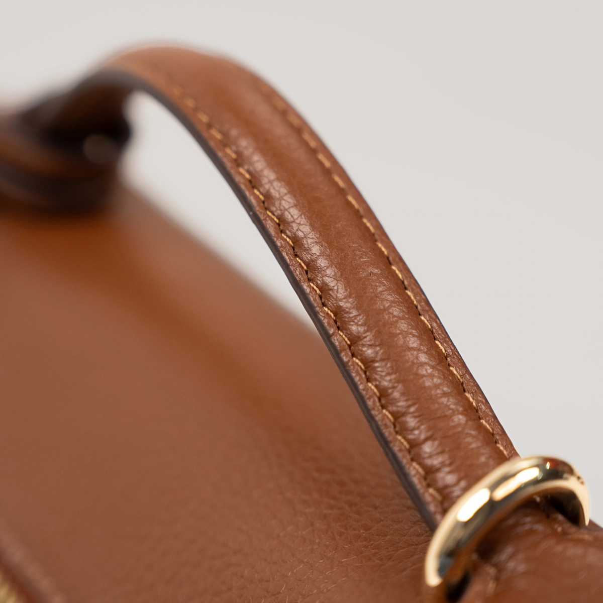 Lodis Stratos Texas Crossbody in Chestnut - Close-Up of Stitched Texas Leather Top Handle with Gold-Tone Ring Hardware | Lodis 1965