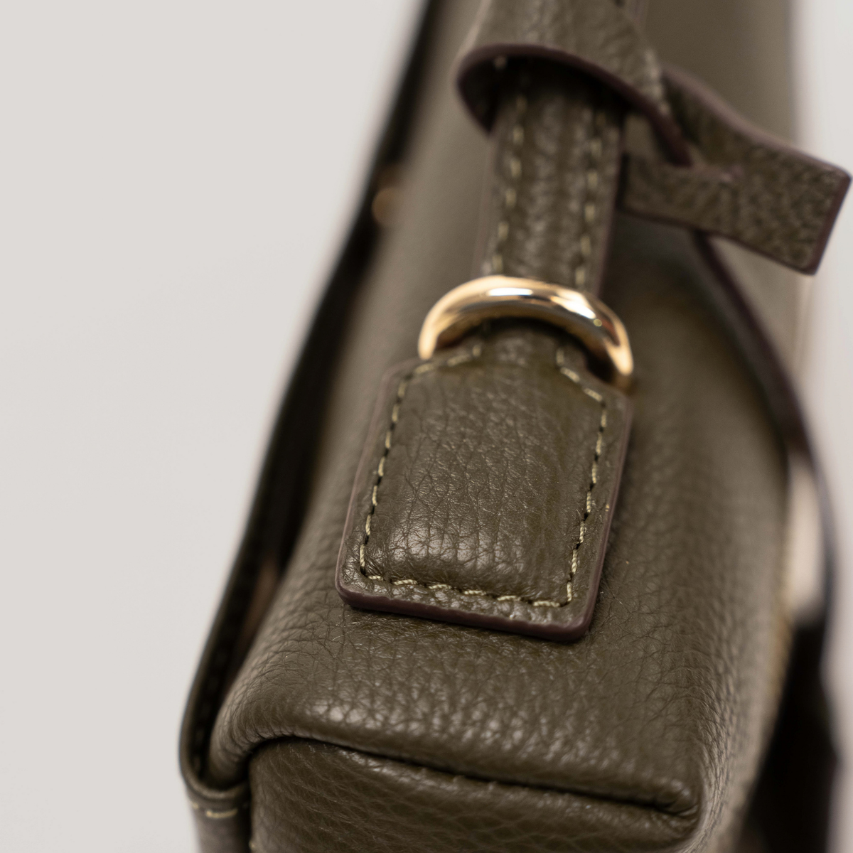 Lodis Stratos Texas Crossbody in Olivine - Close-Up of Stitched Texas Leather Handle Tab with Gold-Tone Ring Hardware | Lodis 1965